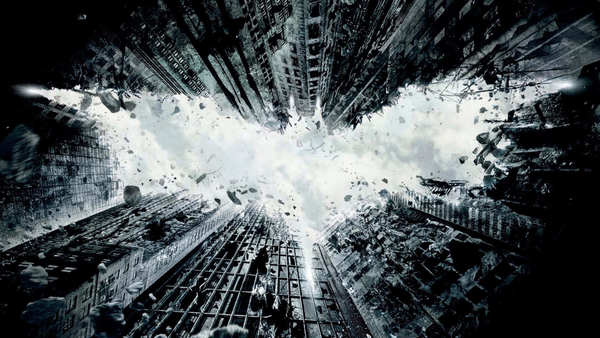 1920 X 1080 Batman 桌布 壁紙 — 一個戲劇性的黑白城市景觀，由碎片和破碎的建築物形成一個巨大的蝙蝠標誌。