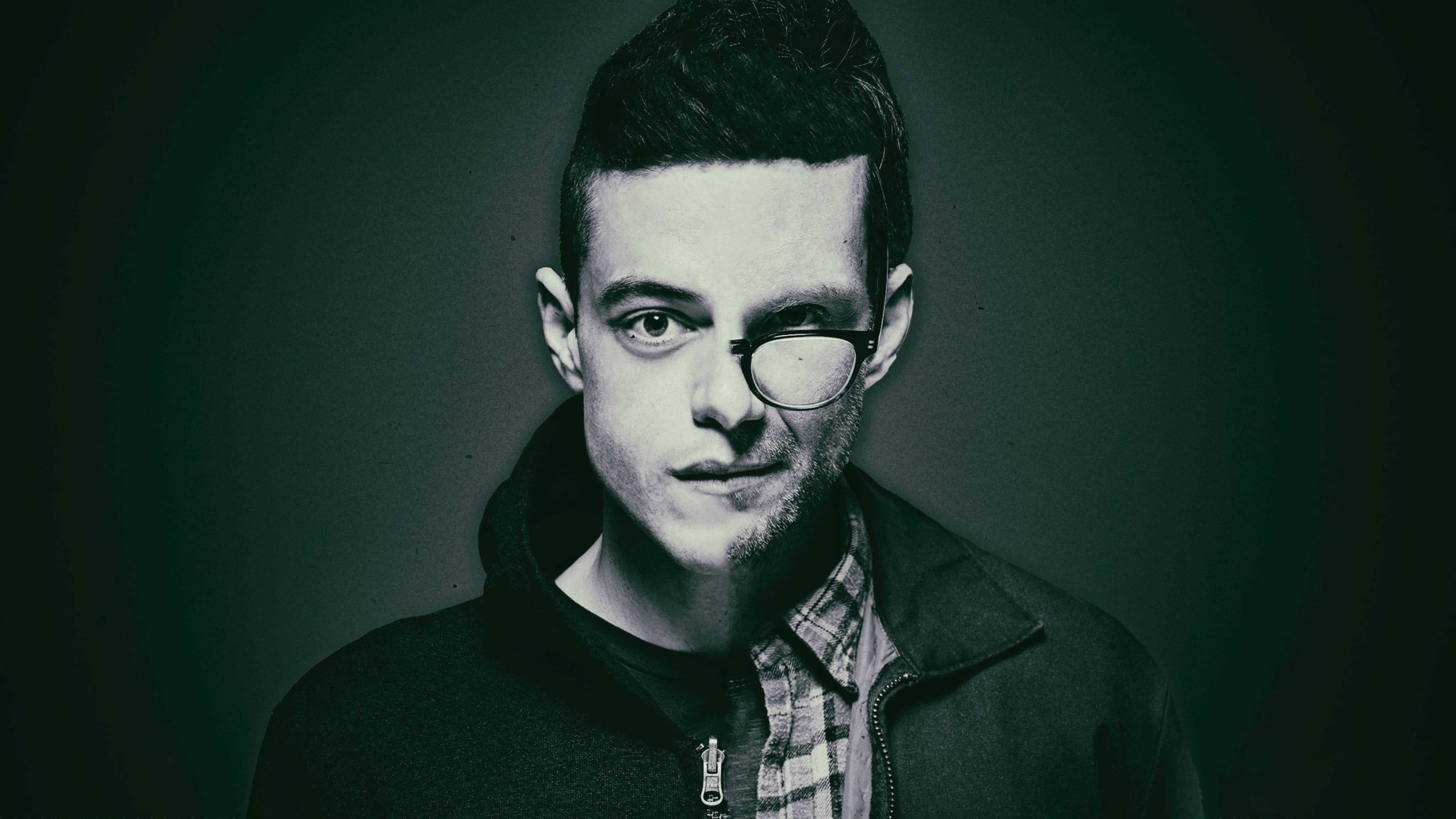 Mr Robot 桌布 壁紙 — 一個戴眼鏡、留鬍渣的年輕男子在深色漸變背景前的憂鬱肖像。