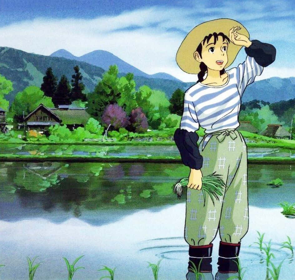 Only Yesterday 桌布 壁紙 — 一個戴草帽的年輕女孩站在稻田裡，手裡拿著綠色的稻稈，背後有山脈和村莊，在明亮的藍天下。