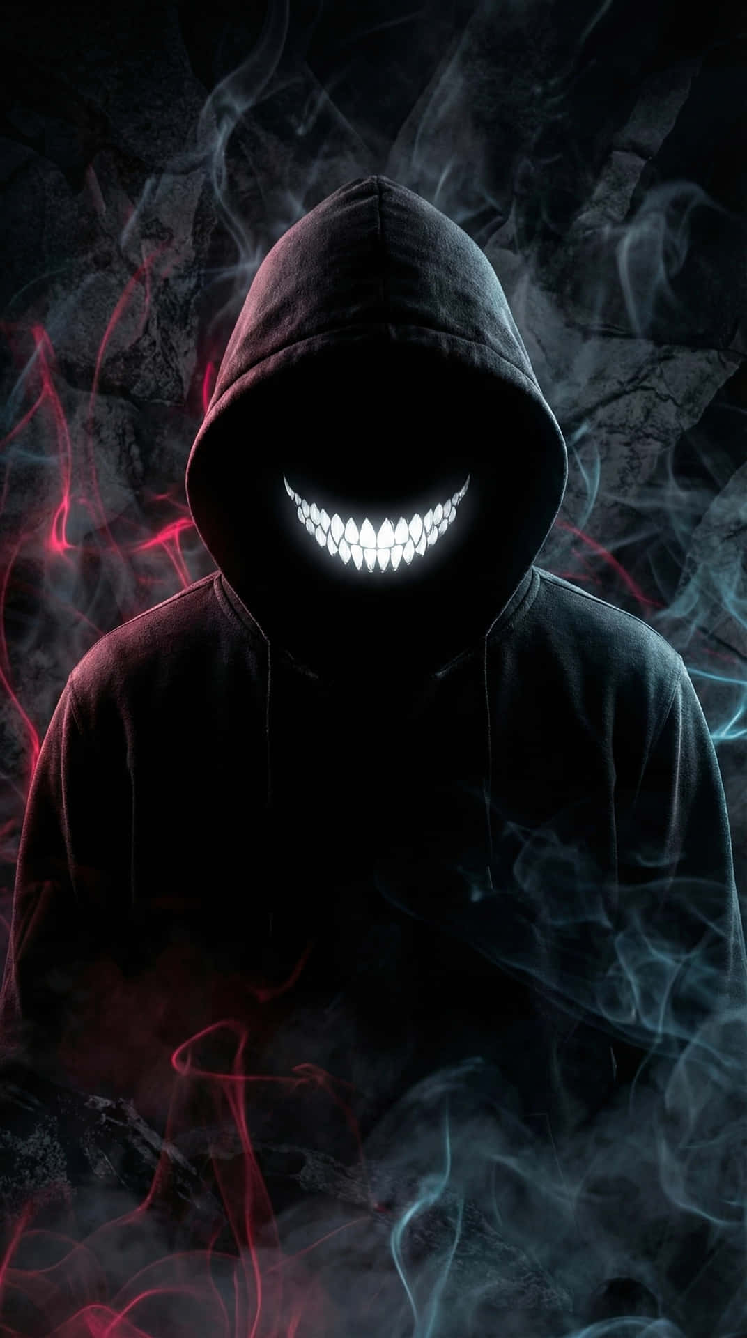 Dark Evil Smile 壁紙 — 一個戴著兜帽的身影，帶著發光的白色鋸齒狀笑容，從旋轉的紅色和藍色煙霧中出現，背景是黑暗的岩石。