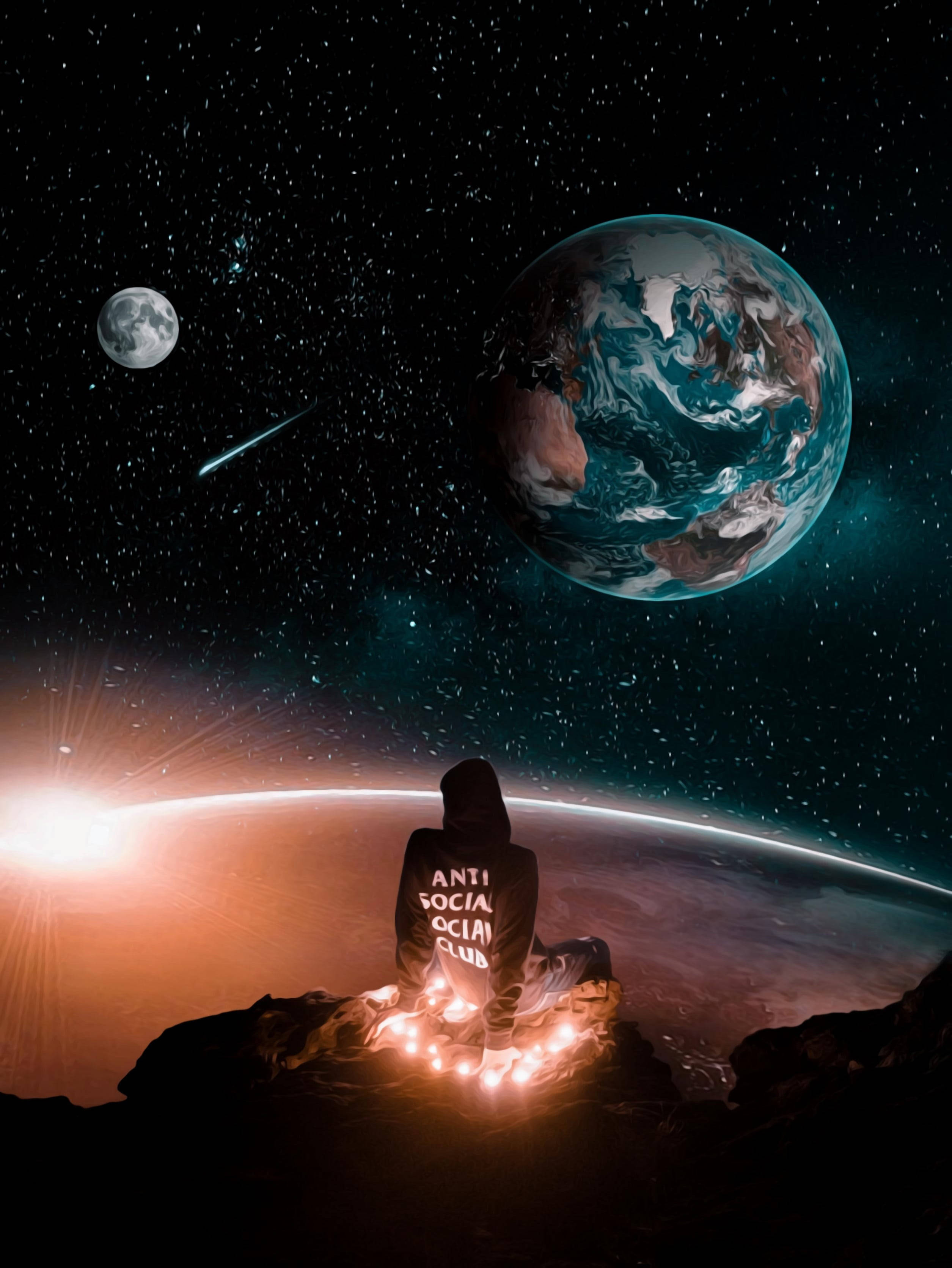 Social 桌布 壁紙 — 一個戴著兜帽的身影坐在岩石上，凝視著發光的地球和月亮，背景是星空和流星。