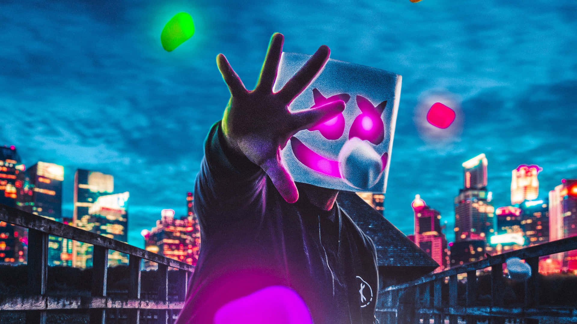 Marshmello 動態圖 桌布 壁紙 — 一個戴著發光粉紅色面具和黑色連帽衫的人夜晚站在屋頂上，向著充滿活力的霓虹燈城市天際線伸出一隻手。