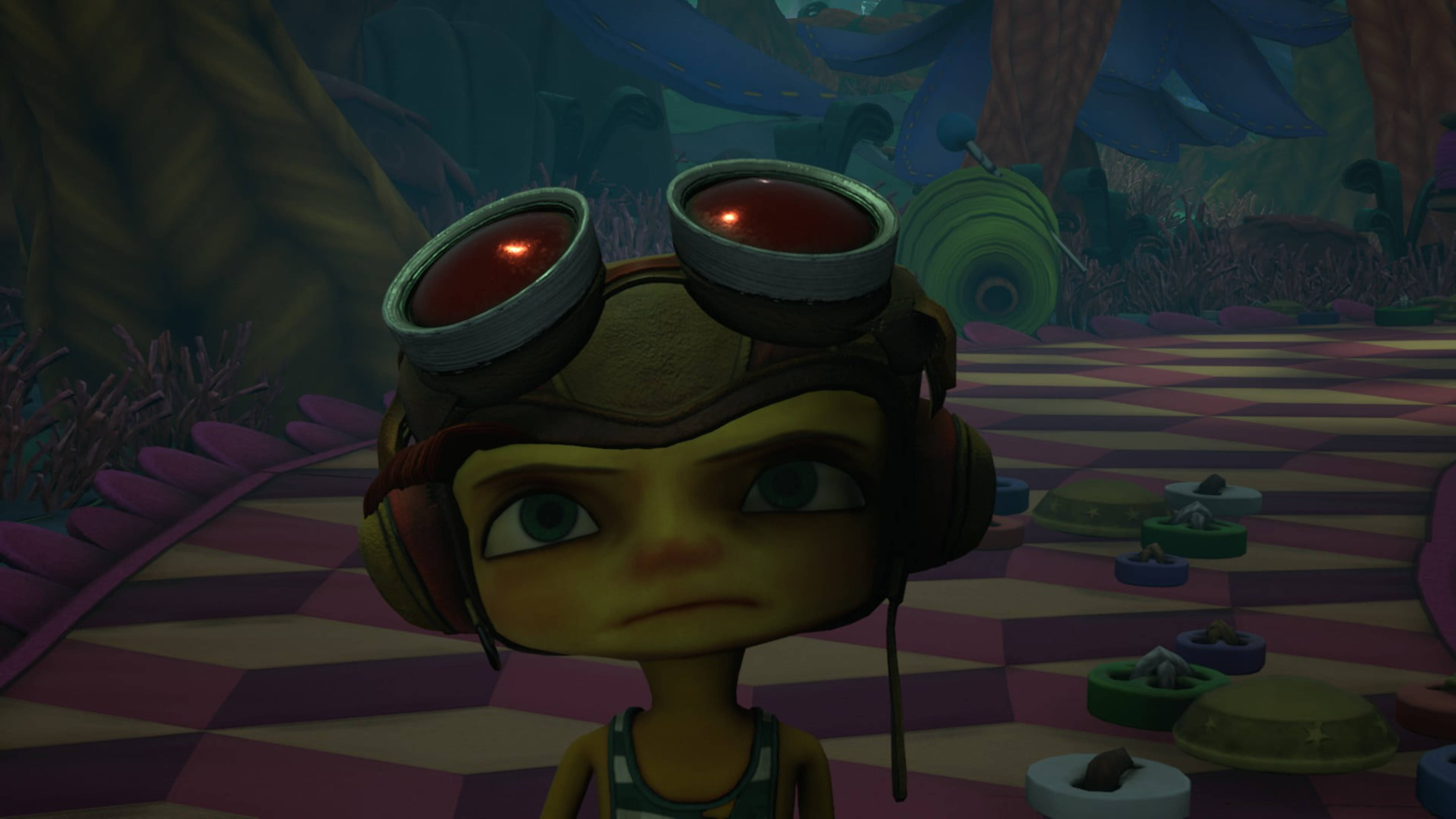 Psychonauts 桌布 壁紙 — 一個戴著發光護目鏡的蒸氣龐克小孩，在一個超現實、色彩繽紛、地板呈棋盤格圖案的外星叢林中凝視前方。