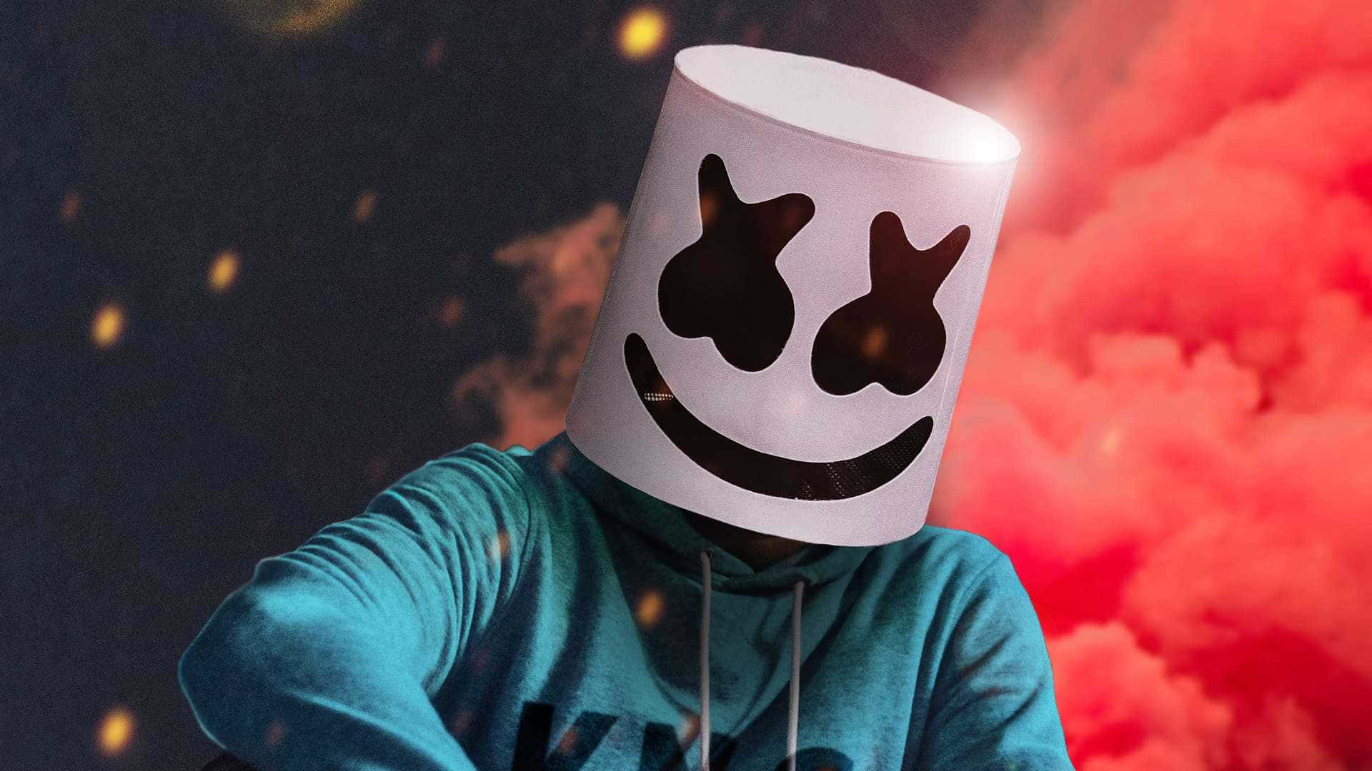 Marshmello 動態圖 桌布 壁紙 — 一個戴著白色棉花糖頭盔、面帶微笑的人，站在戲劇性的紅色煙霧和黑暗天空前，周圍有發光的粒子。