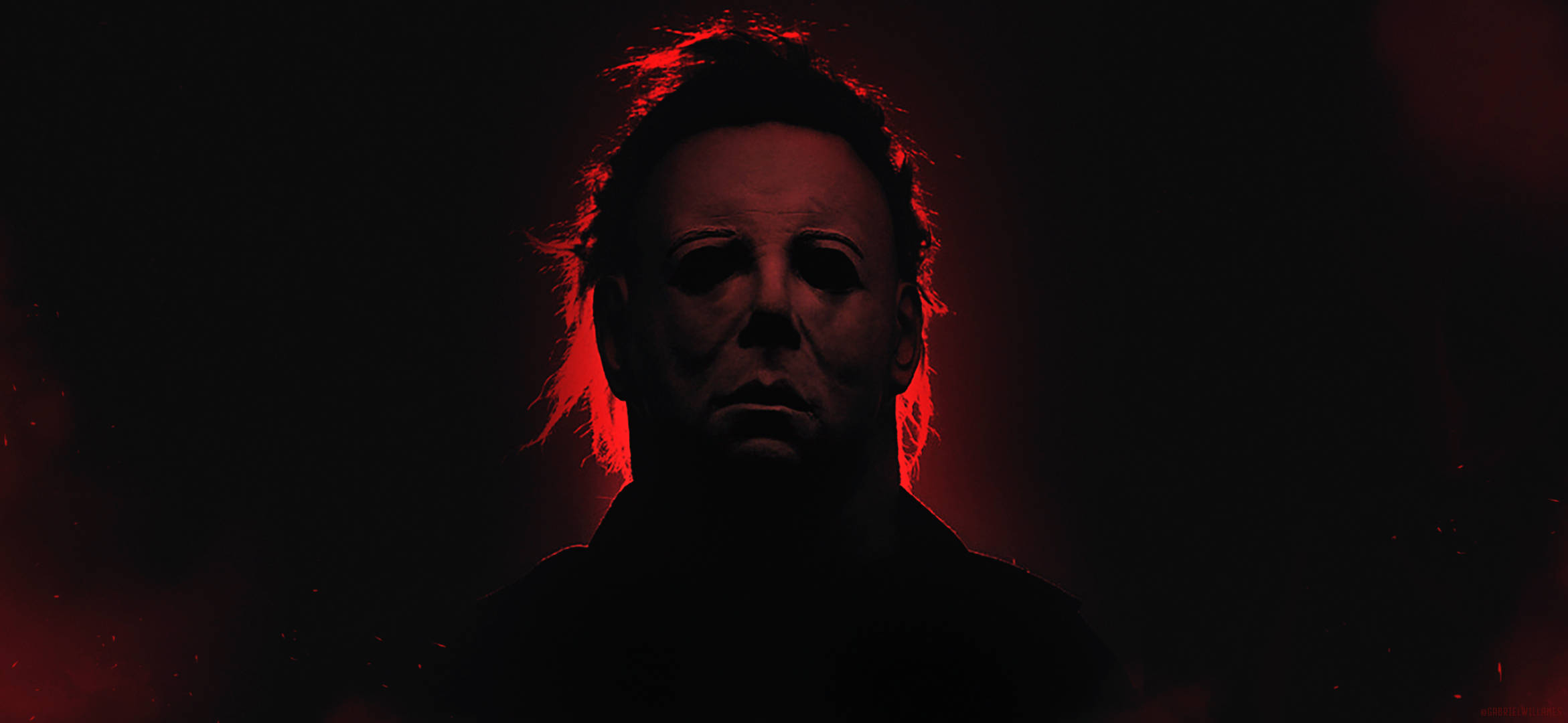 Halloween Kills 桌布 壁紙 — 一個戴著白色面具的威脅人物在黑暗背景下發出紅光。