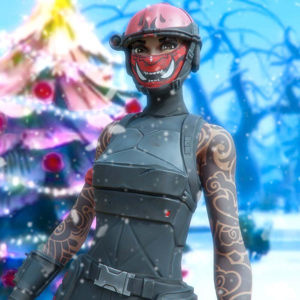 冬天 桌布 壁紙 — 一個戴著紅色惡魔面具、身穿戰術裝備的Fortnite角色，站在雪地冬日場景中，身後有發光的聖誕樹。