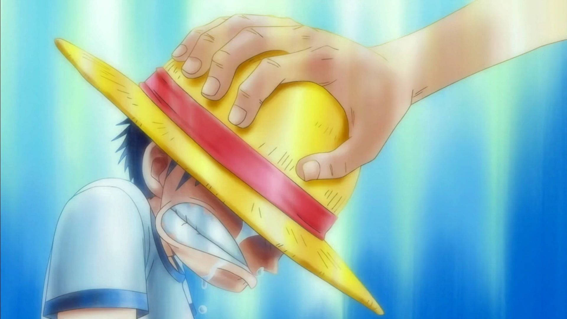 憂鬱動漫男孩 桌布 壁紙 — 一個戴著草帽、意志堅定的動畫男孩，在充滿活力的藍色背景下被一隻巨手擁抱。