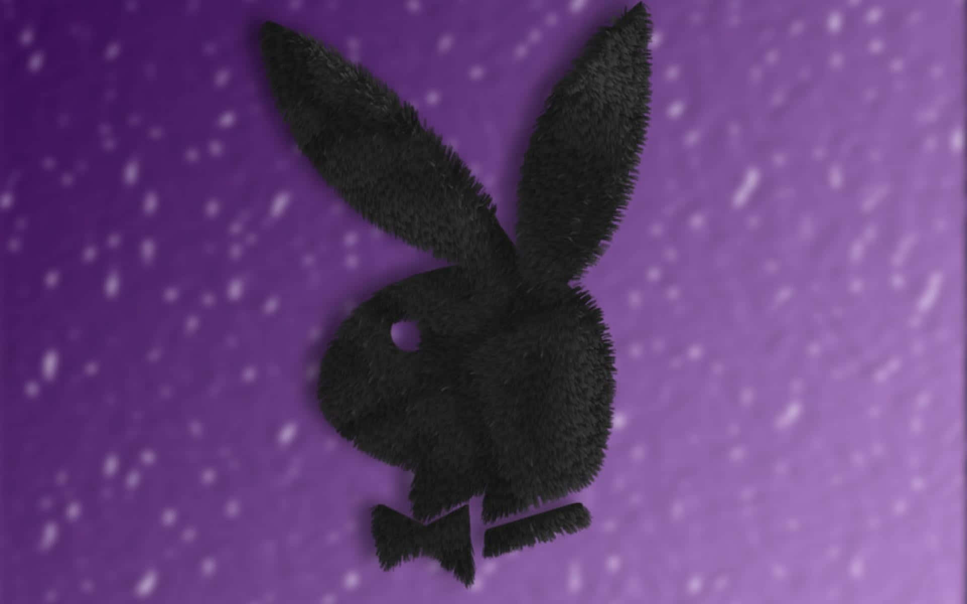 Playboy Aesthetic 桌布 壁紙 — 一個戴著蝴蝶結的黑色毛茸茸兔子剪影，在斑點紫色背景上格外突出。