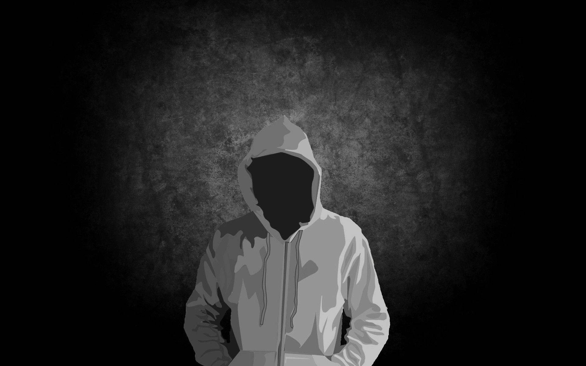 Hoodie 桌布 壁紙 — 一個戴著連帽衫、臉部空白的人物，站在單色調的紋理深色牆前。