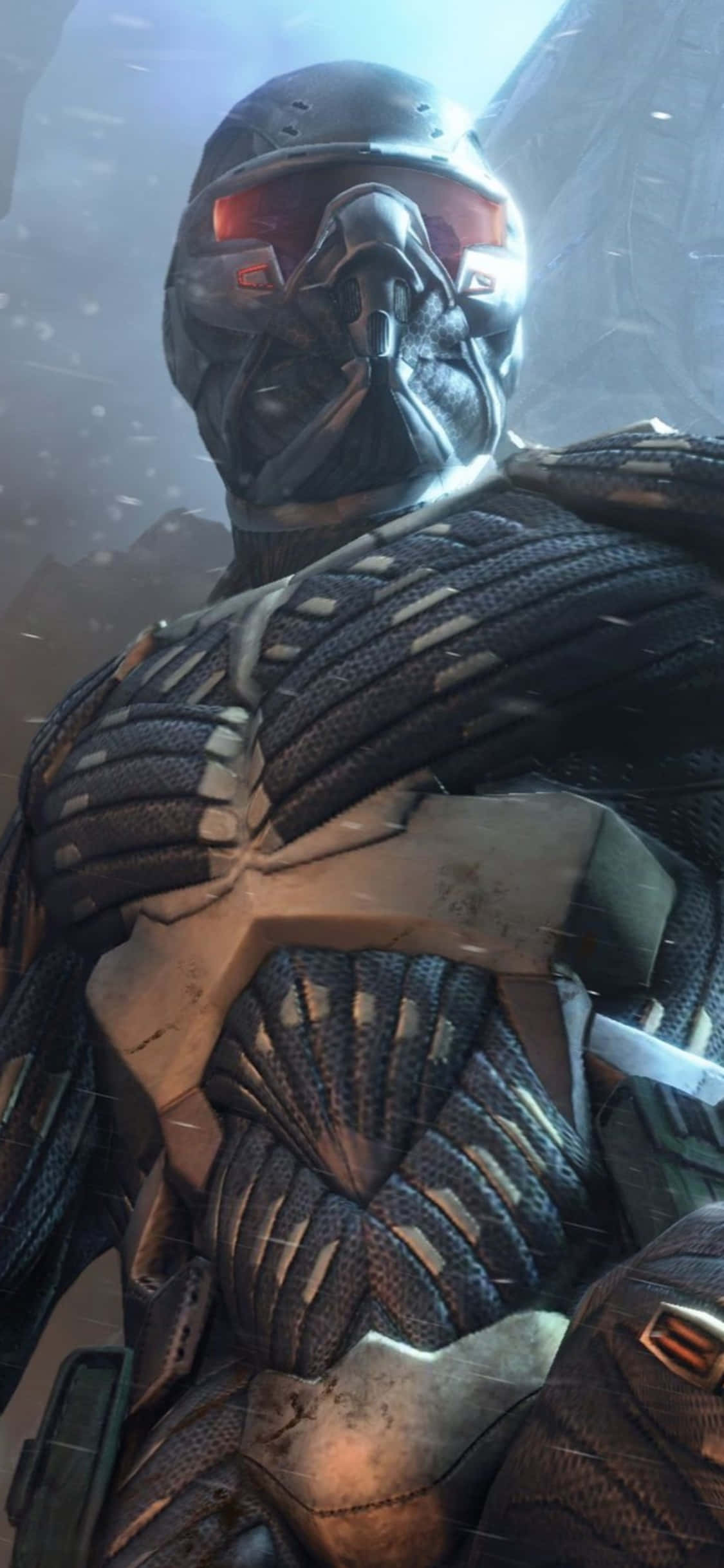 iPhone Xs Crysis Warhead 桌布 壁紙 — 一個戴著面具的戰士，身穿深色裝甲裝備，帶有發光的紅色護目鏡，站在雪地、未來主義環境中的特寫。