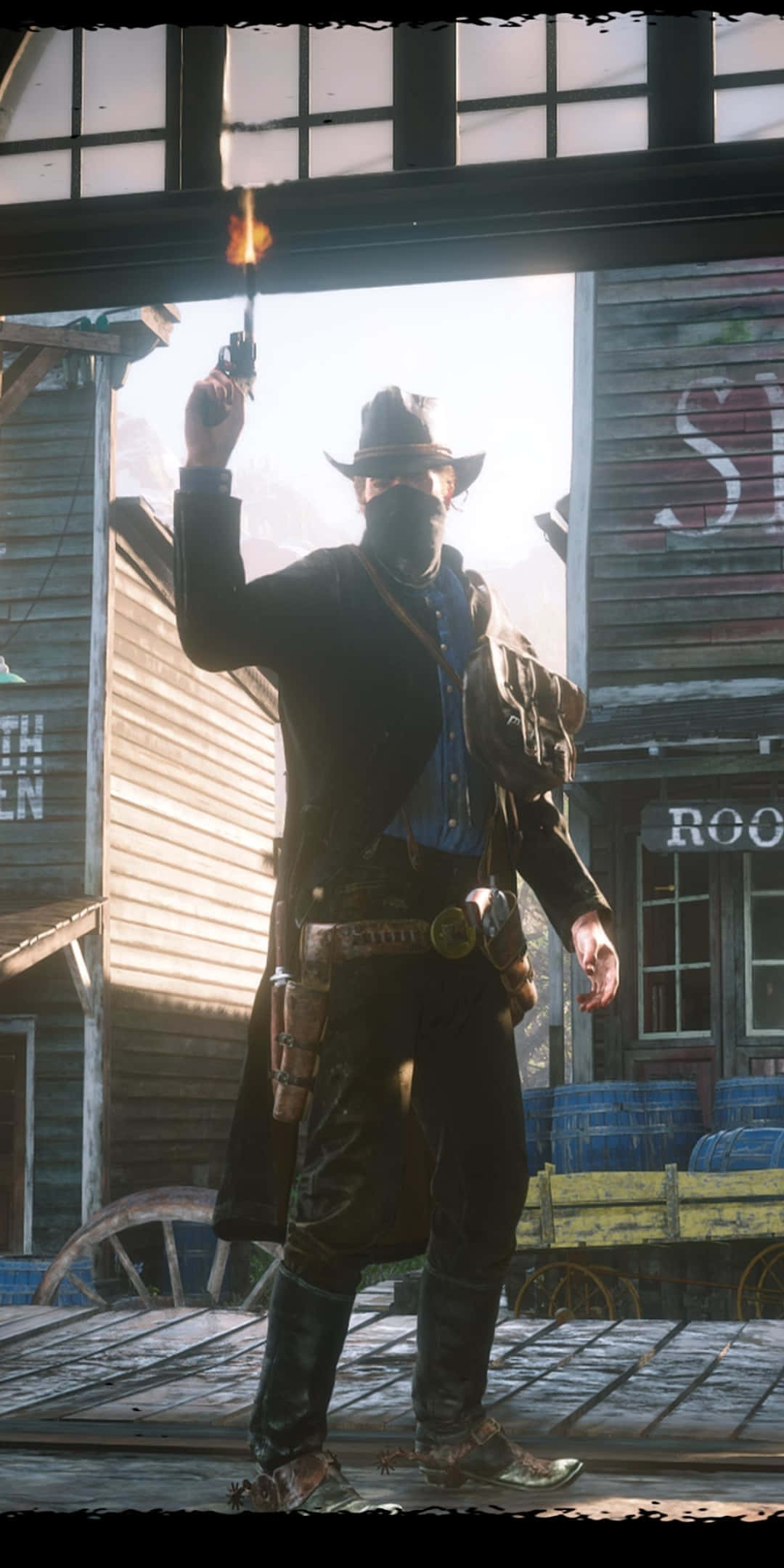 Red Dead Redemtion 2 桌布 壁紙 — 一個戴著面具的牛仔在塵土飛揚的西部小鎮，向著陽光普照的木建築外牆向上開槍，手槍冒著煙。