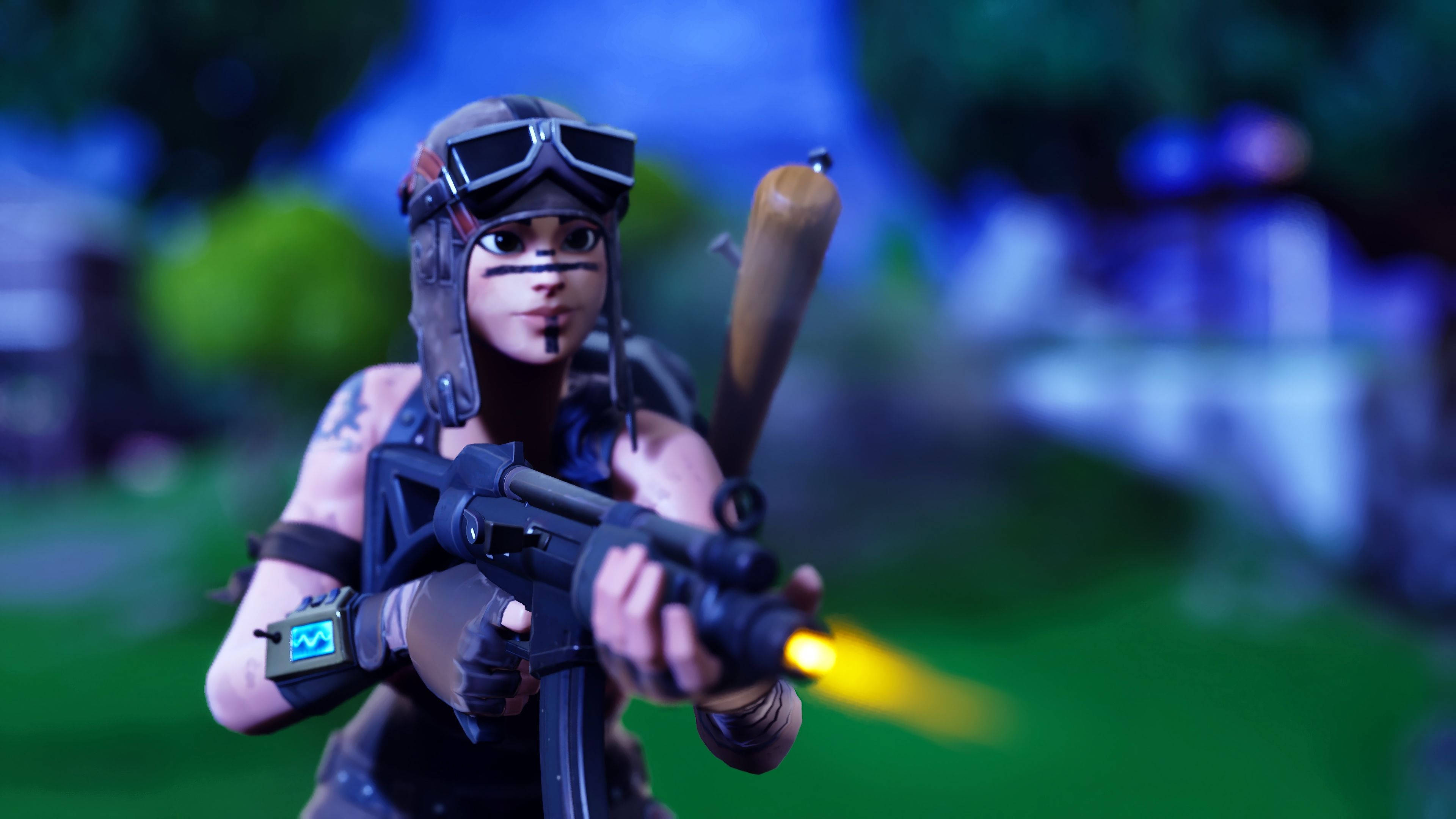 Renegade 桌布 壁紙 — 一個戴護目鏡和臉部彩繪的 Fortnite 角色在模糊的戶外環境中發射發光武器。