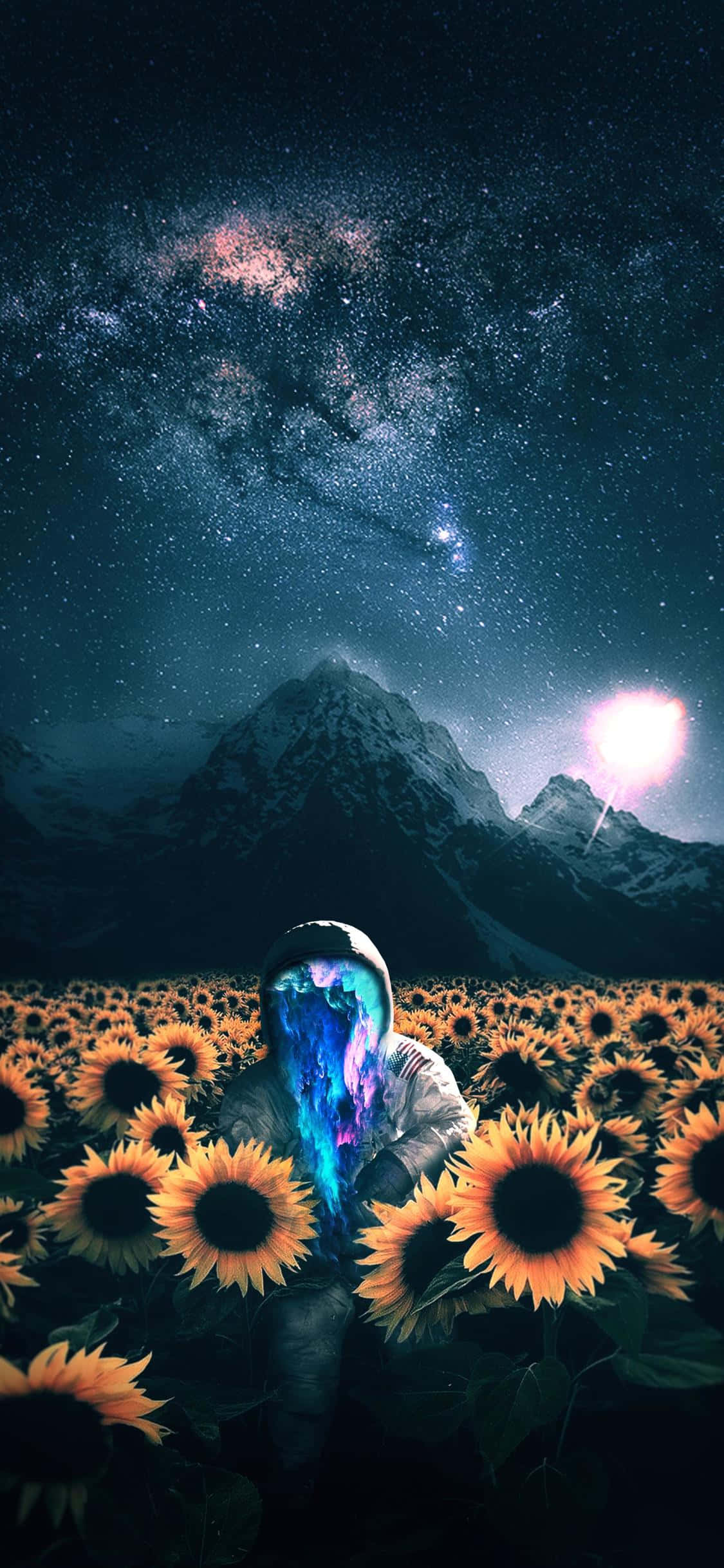 Astronaut iPhone 桌布 壁紙 — 一個擁有發光宇宙頭髮的人物站在向日葵田裡，下方是星空，上方有明亮的天體和積雪的山峰。