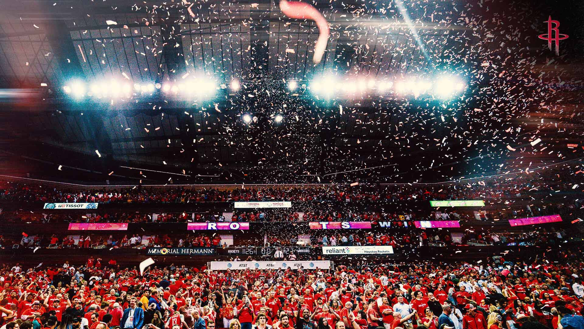 Houston Rockets 桌布 壁紙 — 一個擠滿人的籃球場爆發出歡呼聲，彩色紙屑如雨般灑落在身穿紅色衣服的歡呼球迷身上。