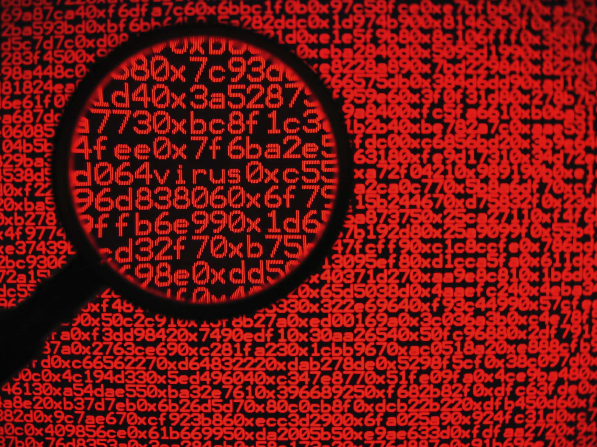 Malicious 桌布 壁紙 — 一個放大鏡懸浮在黑色背景上發光的紅色十六進制代碼上方，揭示病毒警報。