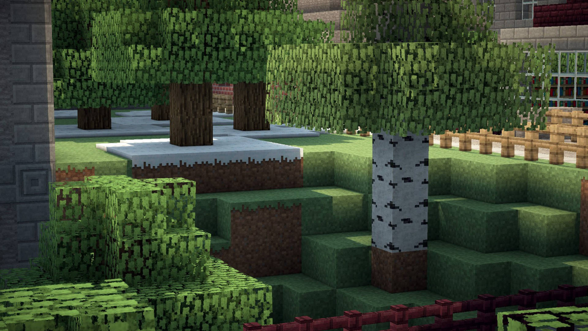 森林 桌布 壁紙 — 一個方塊狀的Minecraft景觀，包含像素化的樹木、草地和石頭結構，在明亮的日光下。