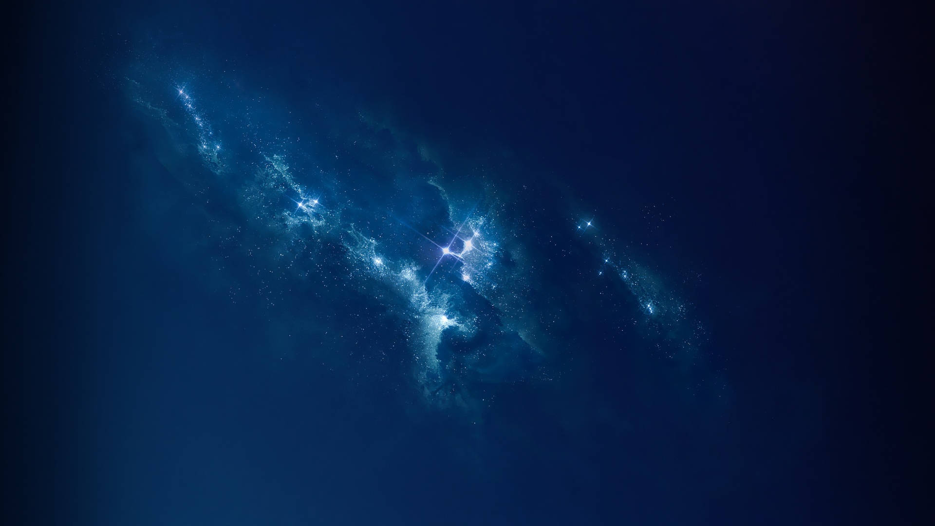 宇宙美學 桌布 壁紙 — 一個旋轉的宇宙星雲在深靛藍色的太空虛空中發出明亮的藍色星光。