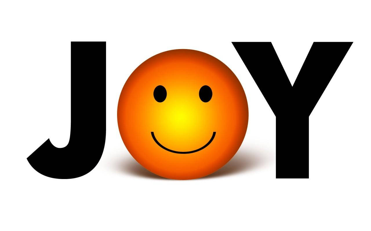 Joy 桌布 壁紙 — 一個明亮橙色微笑的球體取代了單詞JOY中的字母O，在白色背景上投射出柔和的陰影。