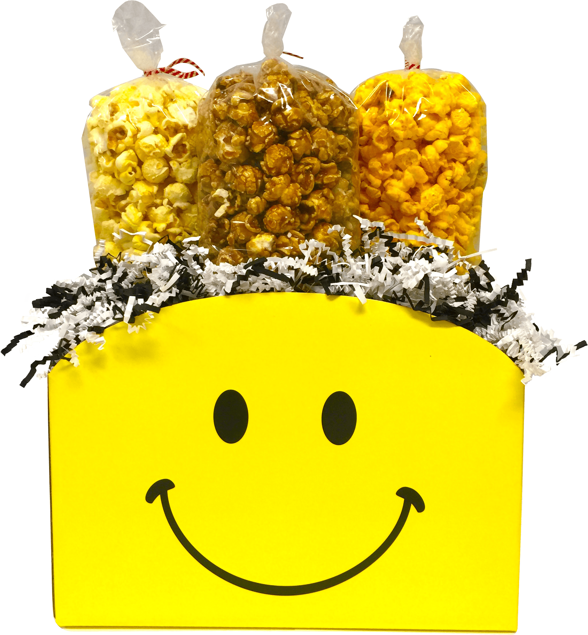 Smiley 桌布 壁紙 — 一個明亮的黃色盒子，上面有笑臉，裡面裝著三袋爆米花，上面覆蓋著黑白碎紙。