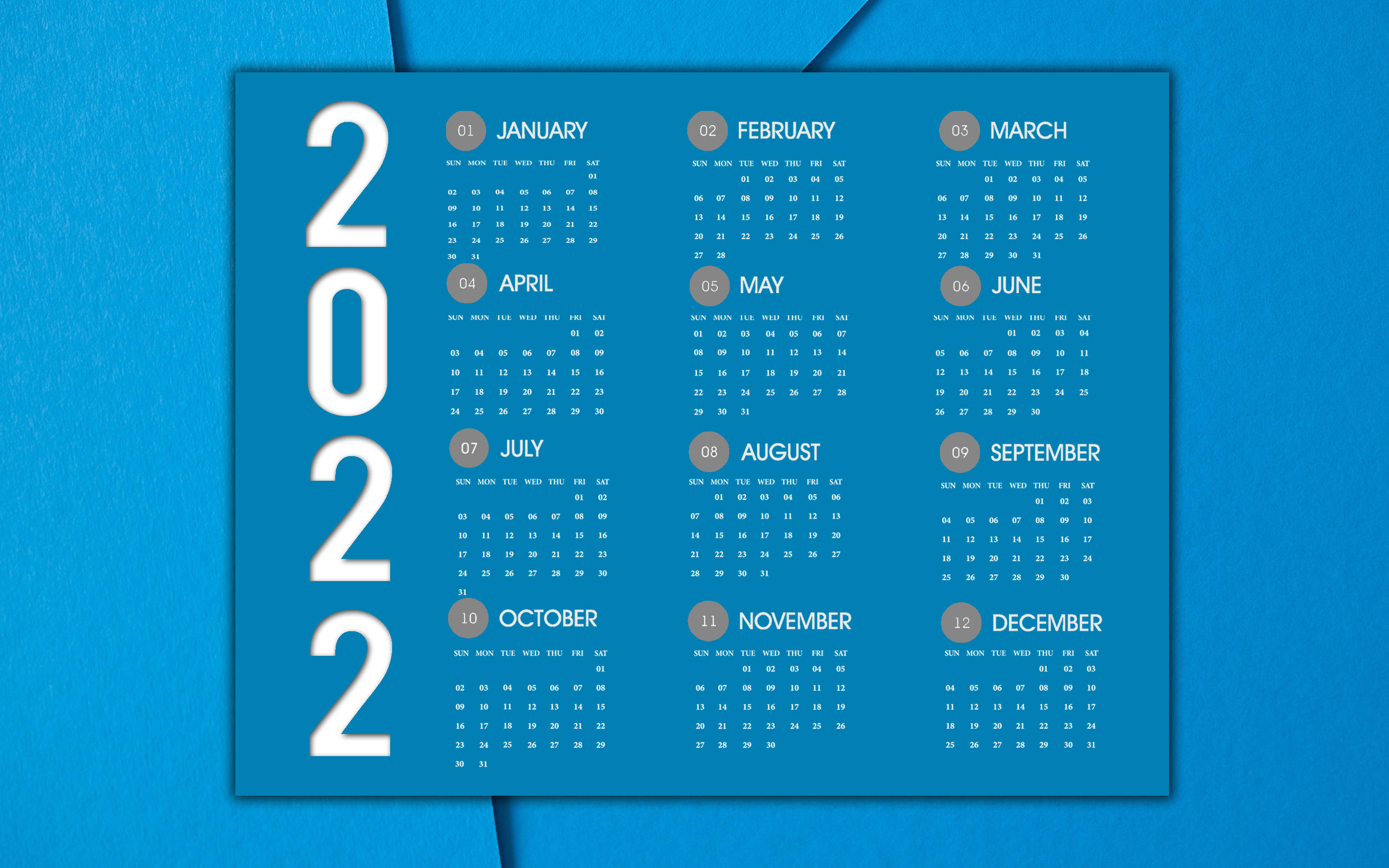 Calendar 桌布 壁紙 — 一個時尚的2022年年曆，白色文字在藍色背景上，放置在帶有紋理的藍色表面上。