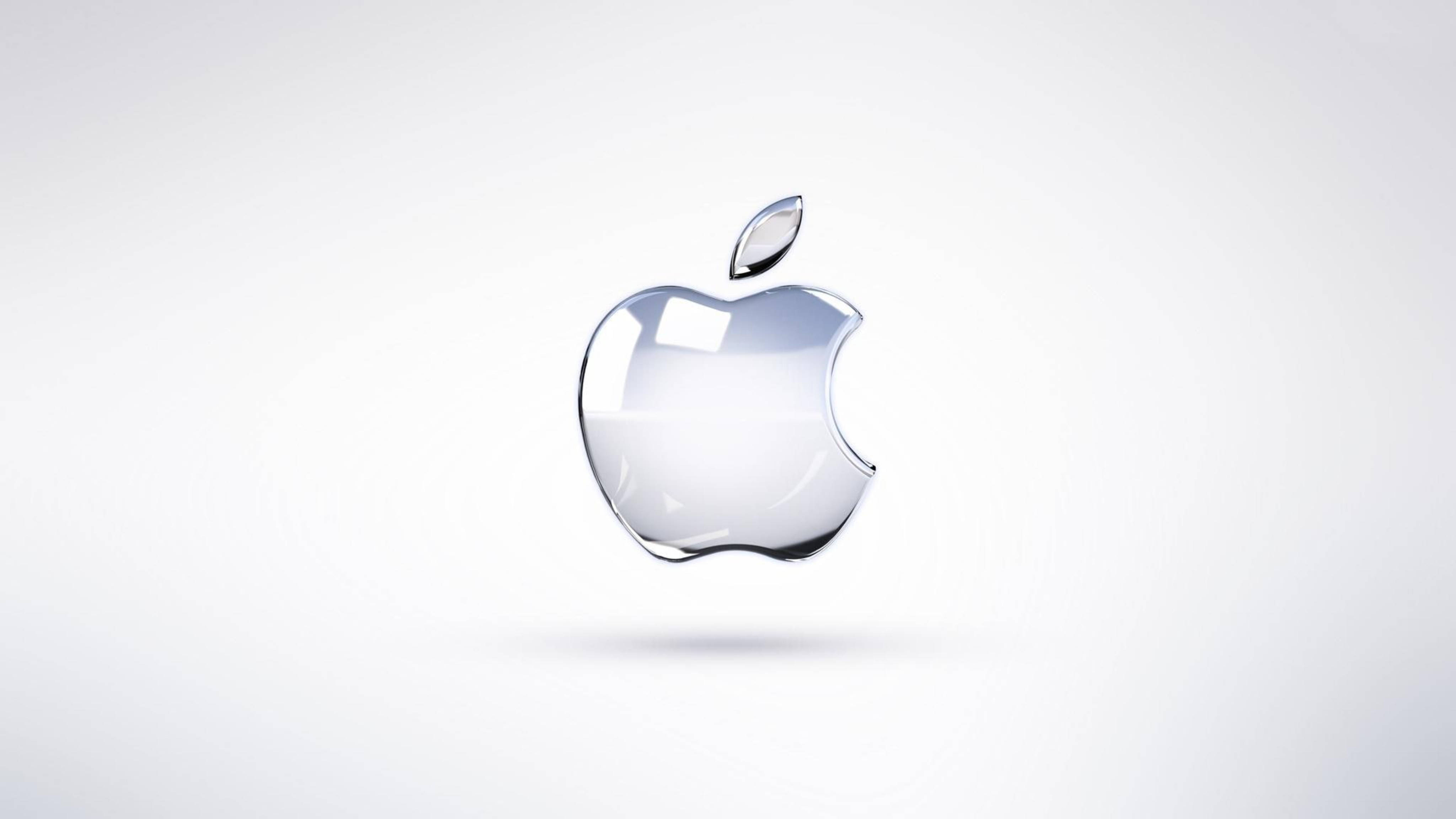Apple 4K Ultra HD 桌布 壁紙 — 一個時尚的玻璃般Apple標誌漂浮在極簡白色背景上，帶有柔和陰影。