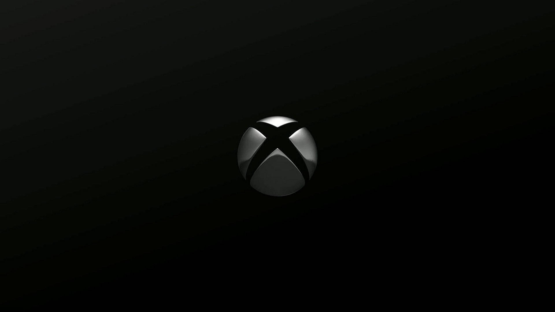 Xbox 桌布 壁紙 — 一個時尚的銀色 Xbox 標誌居中在漸變黑色背景上，帶有微妙的燈光高光。