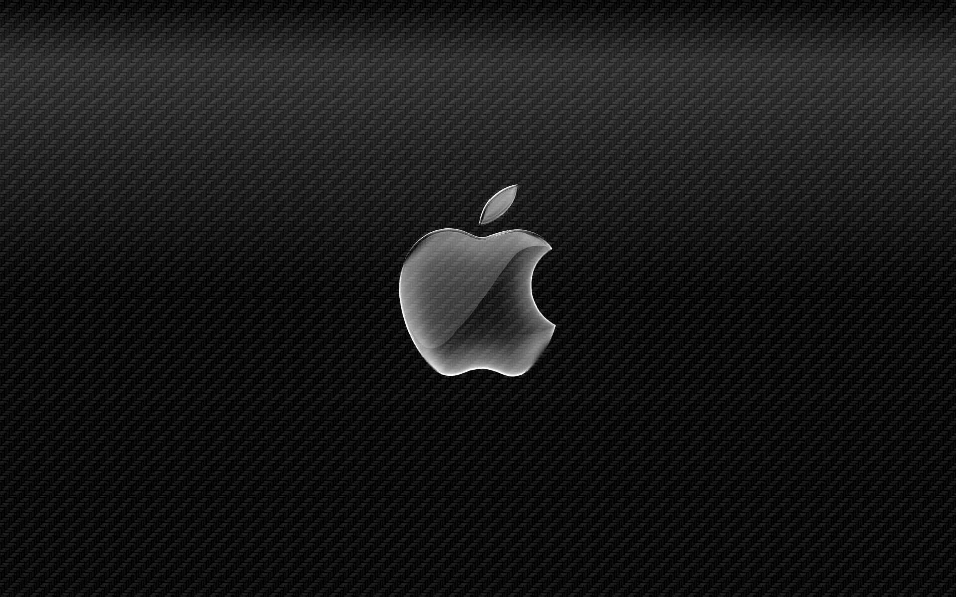 Carbon 桌布 壁紙 — 一個時尚的銀色Apple標誌在紋理黑色碳纖維背景上閃耀。