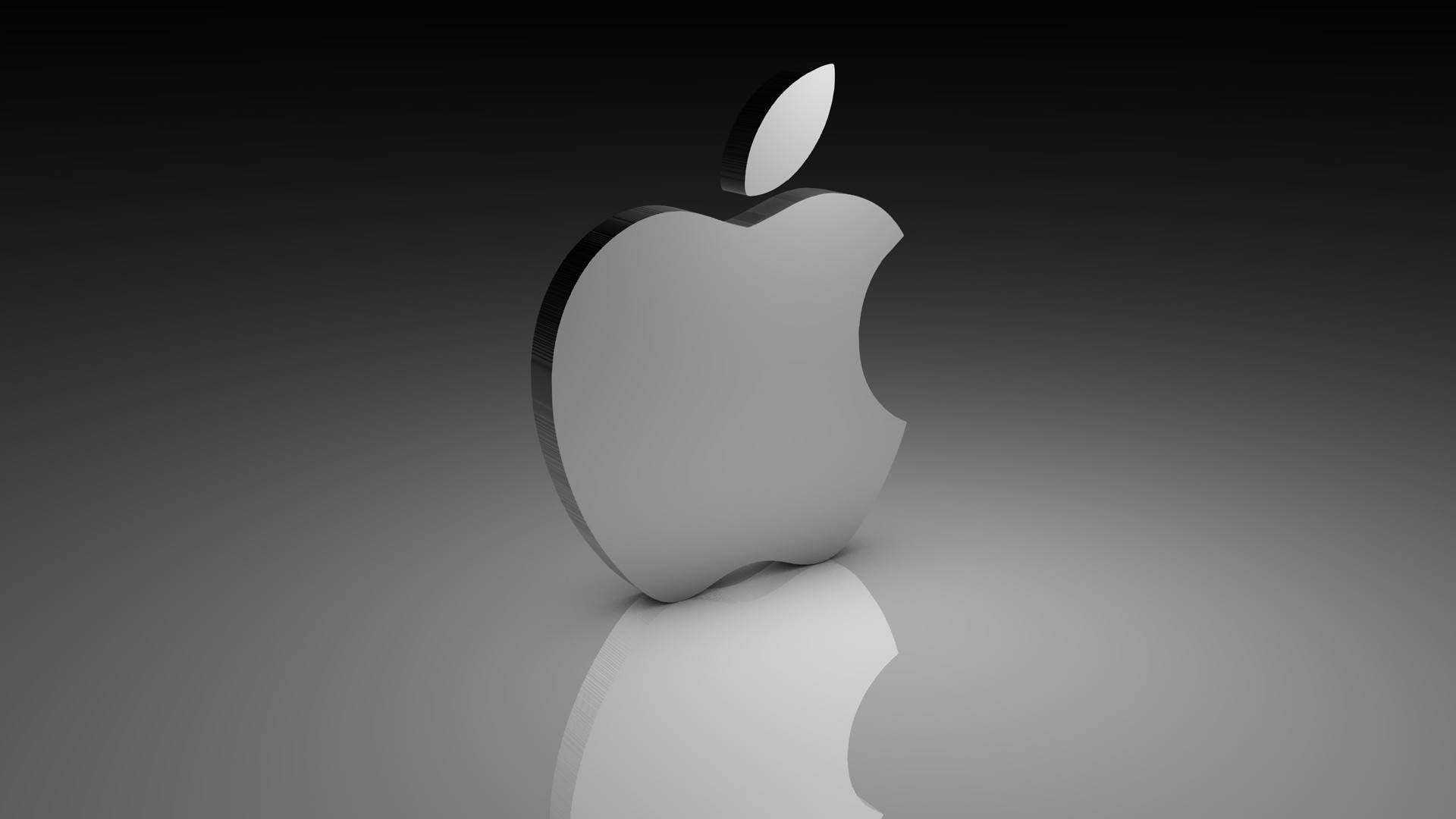 Mac Os 桌布 壁紙 — 一個時尚的銀色Apple標誌居中放置在反射表面上，背景為漸變黑色。
