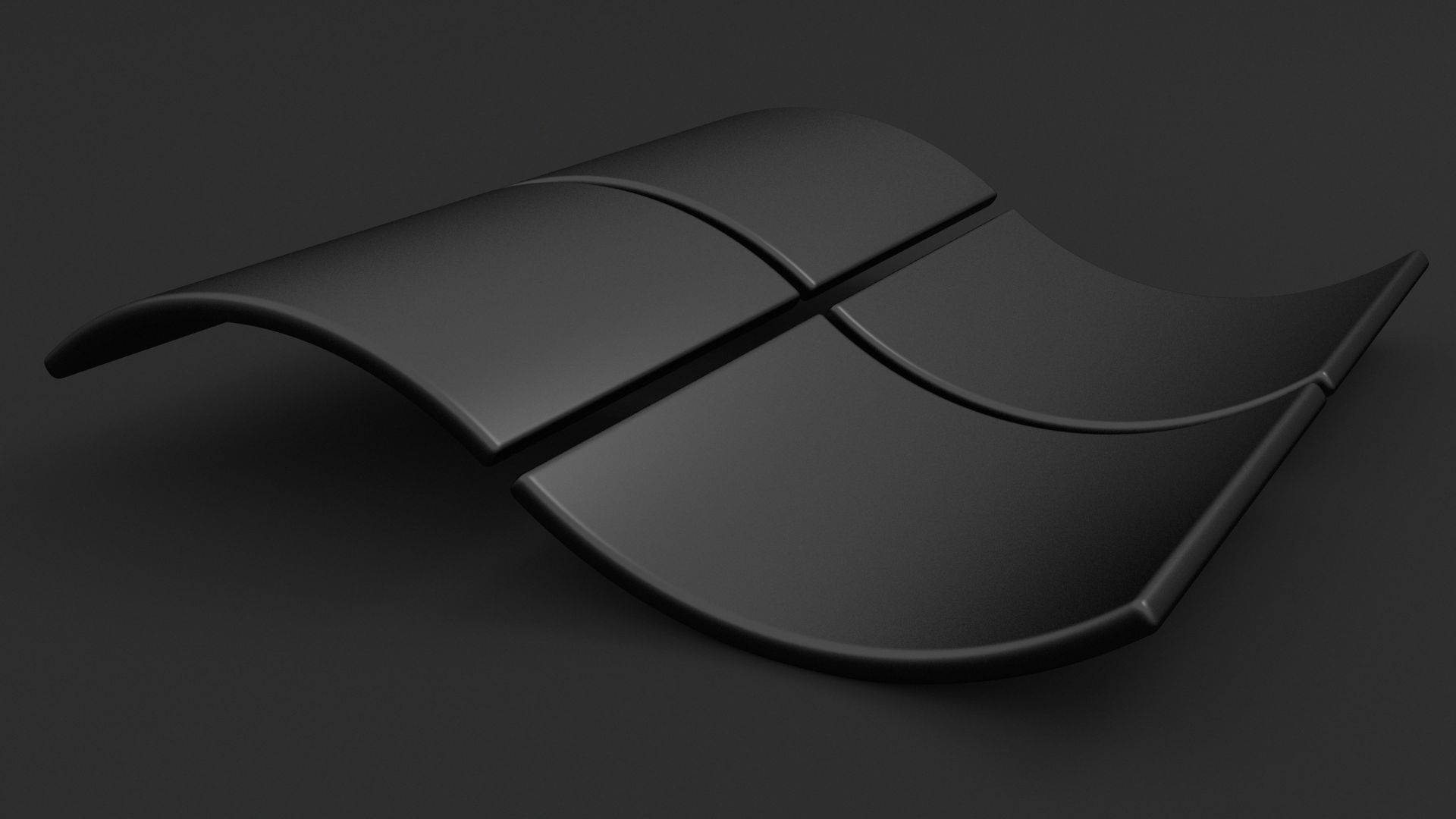 Best Dark 桌布 壁紙 — 一個時尚的黑色3D Windows標誌放置在深色表面上，柔和的光線突出了其彎曲邊緣。