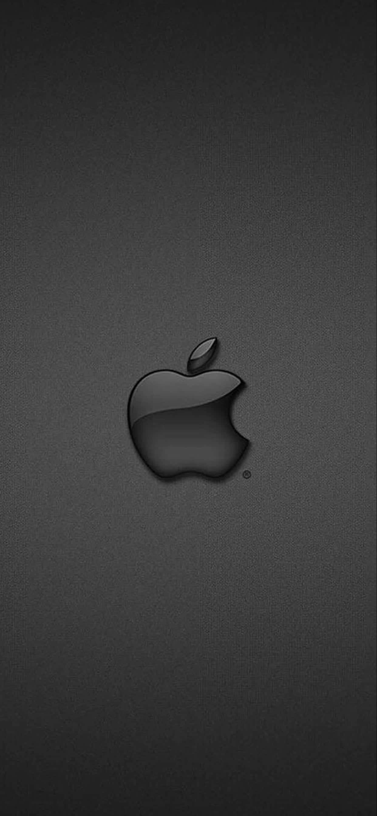 黑色 桌布 壁紙 — 一個時尚的黑色Apple標誌，居中放置在帶有細微漸變照明的紋理深灰色背景上。