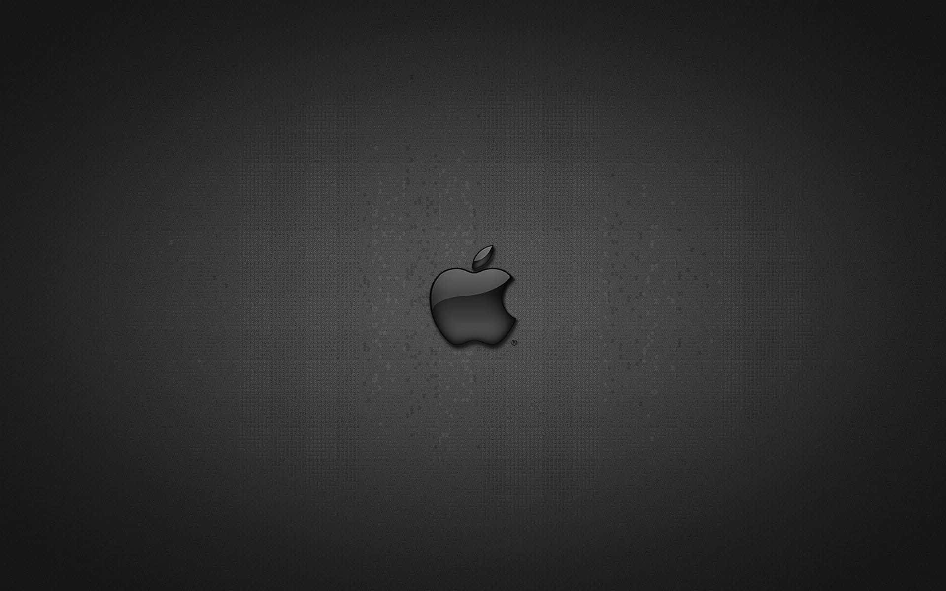 蘋果 桌布 壁紙 — 一個時尚的黑色Apple標誌，居中放置在帶有細微紋理的深灰色漸變背景上。