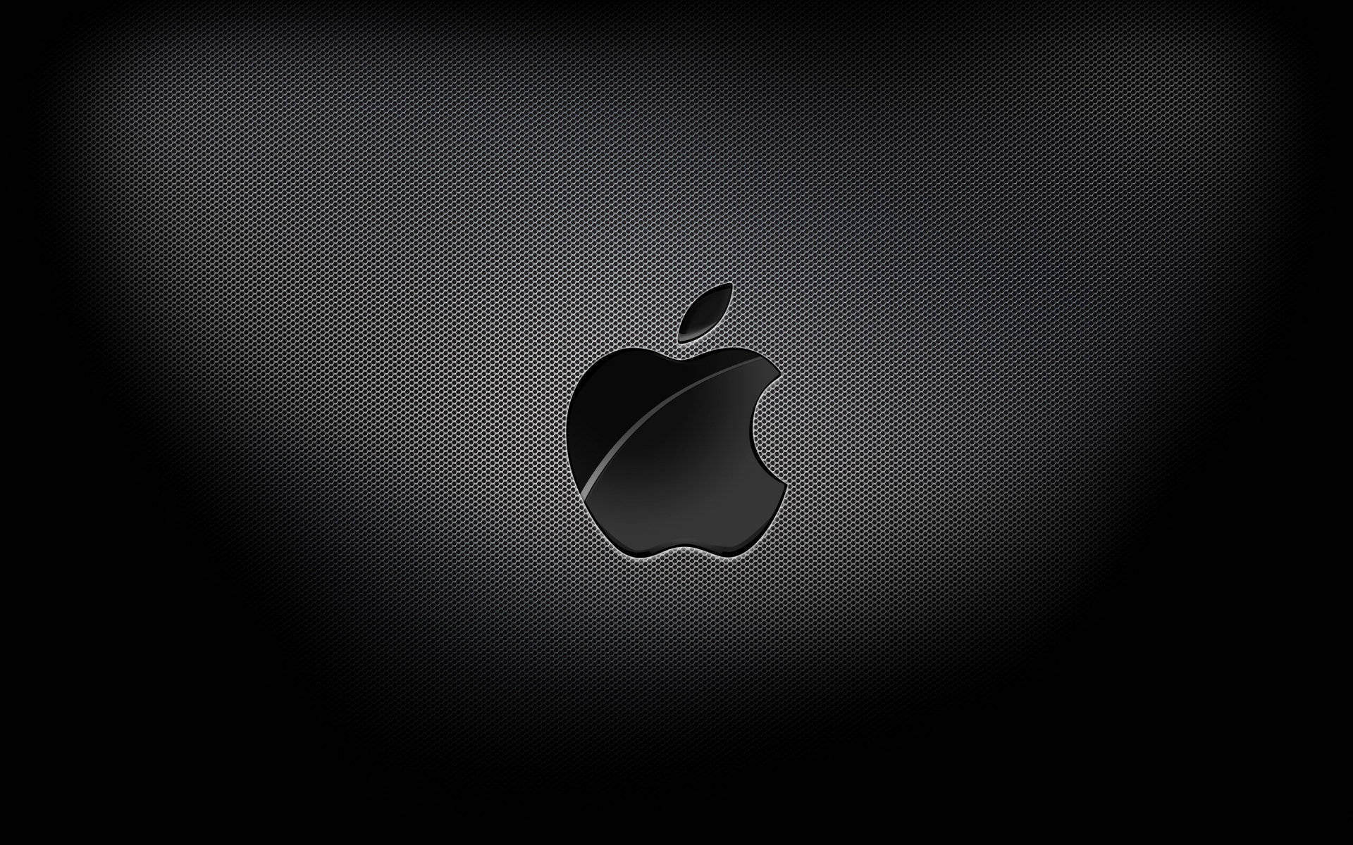 macOS 桌布 壁紙 — 一個時尚的黑色Apple標誌居中於深色紋理背景上，帶有微妙的漸變照明。