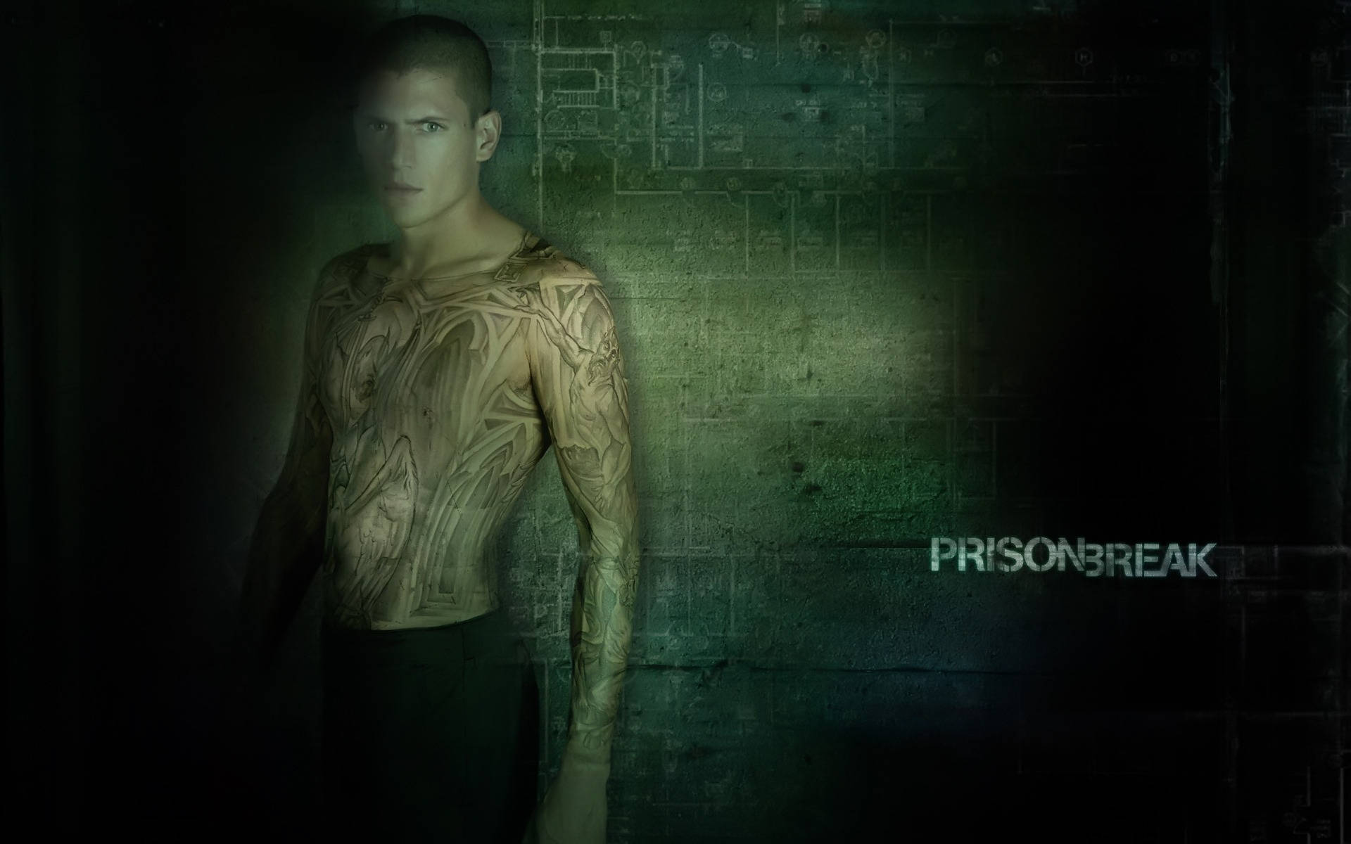 Prison 桌布 壁紙 — 一個有複雜刺青的男人站在一個光線昏暗、牆壁呈綠色且有模糊藍圖標記的房間裡。