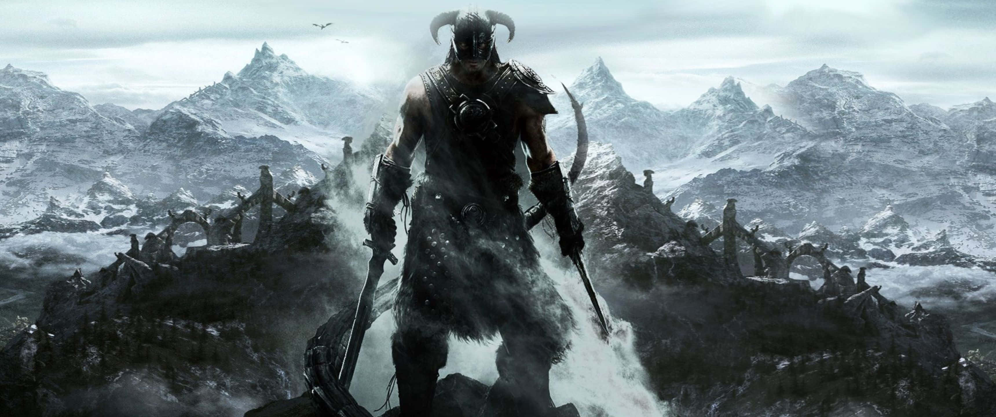 3440x1440p The Elder Scrolls V Skyrim 桌布 壁紙 — 一個有角的戰士身穿黑色盔甲，站在白雪覆蓋的山頂上，手持兩把劍，背後是暴風雨的天空和鋸齒狀的山峰。