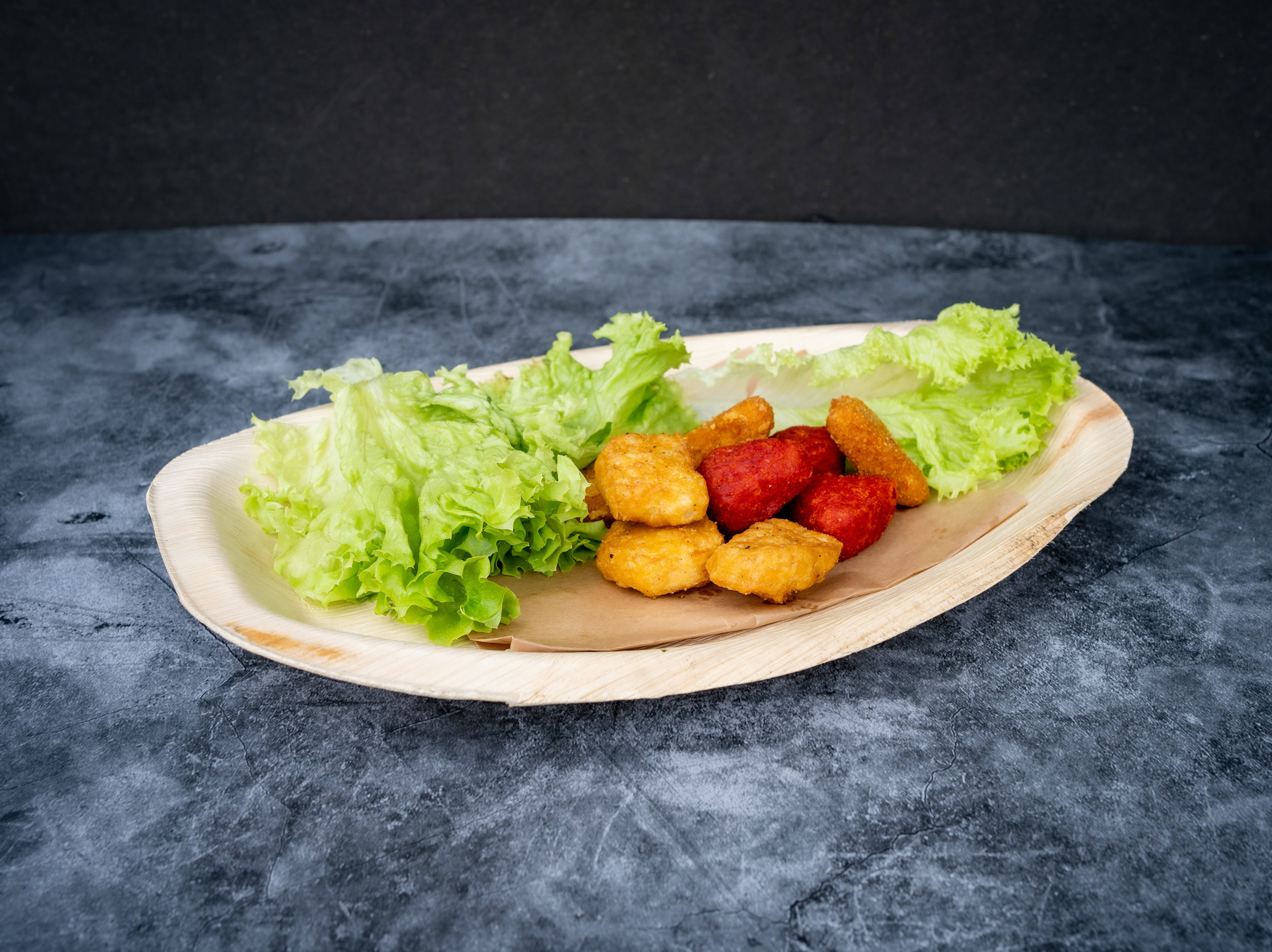 食物動圖 桌布 壁紙 — 一個木盤上放著新鮮的綠色生菜和金黃色的炸雞塊，背景是深色紋理。