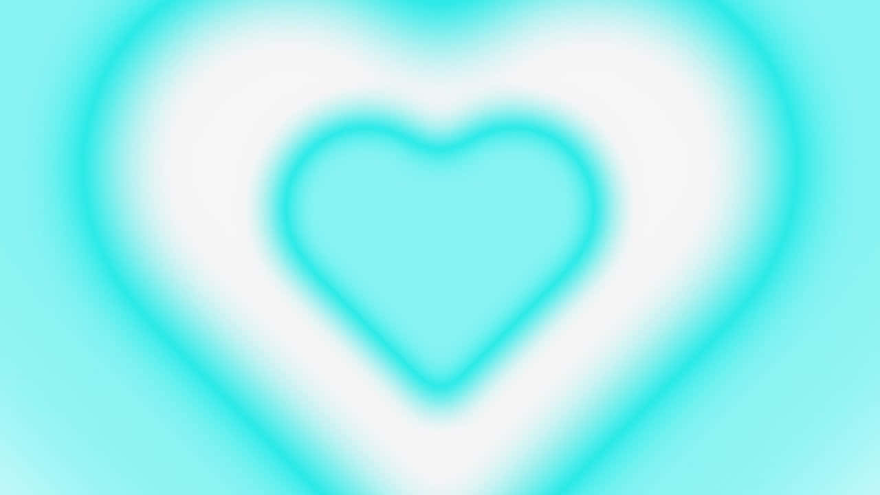 Y2k Heart 桌布 壁紙 — 一個柔和發光的心形圖案，在模糊的漸變背景上散發出溫柔的藍綠色光芒。