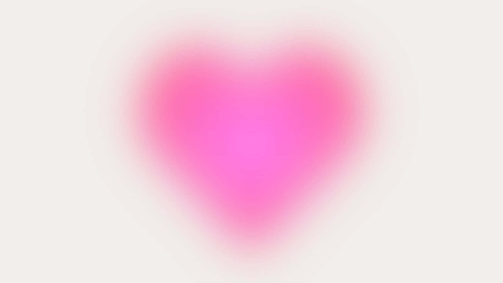 一個在淺色背景上帶有柔和漸變邊緣的發光粉紅色心形。 — 愛心 GIF 壁紙