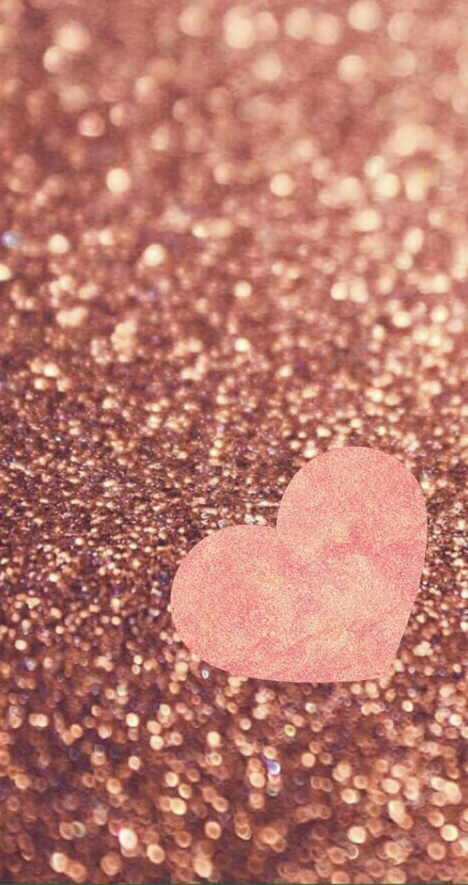 Glitter Pink Hearts 桌布 壁紙 — 一個柔軟的粉紅色心形放在閃閃發光的玫瑰金閃粉背景上，帶有散景光效。