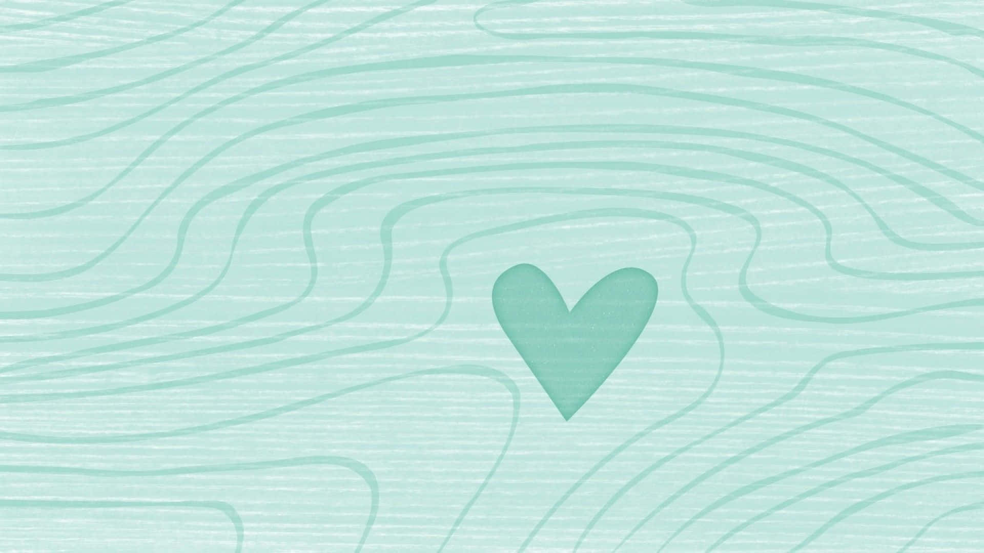 Green Heart 桌布 壁紙 — 一個柔軟的薄荷綠色心形位於流動波浪線條的中心，背景帶有紋理。