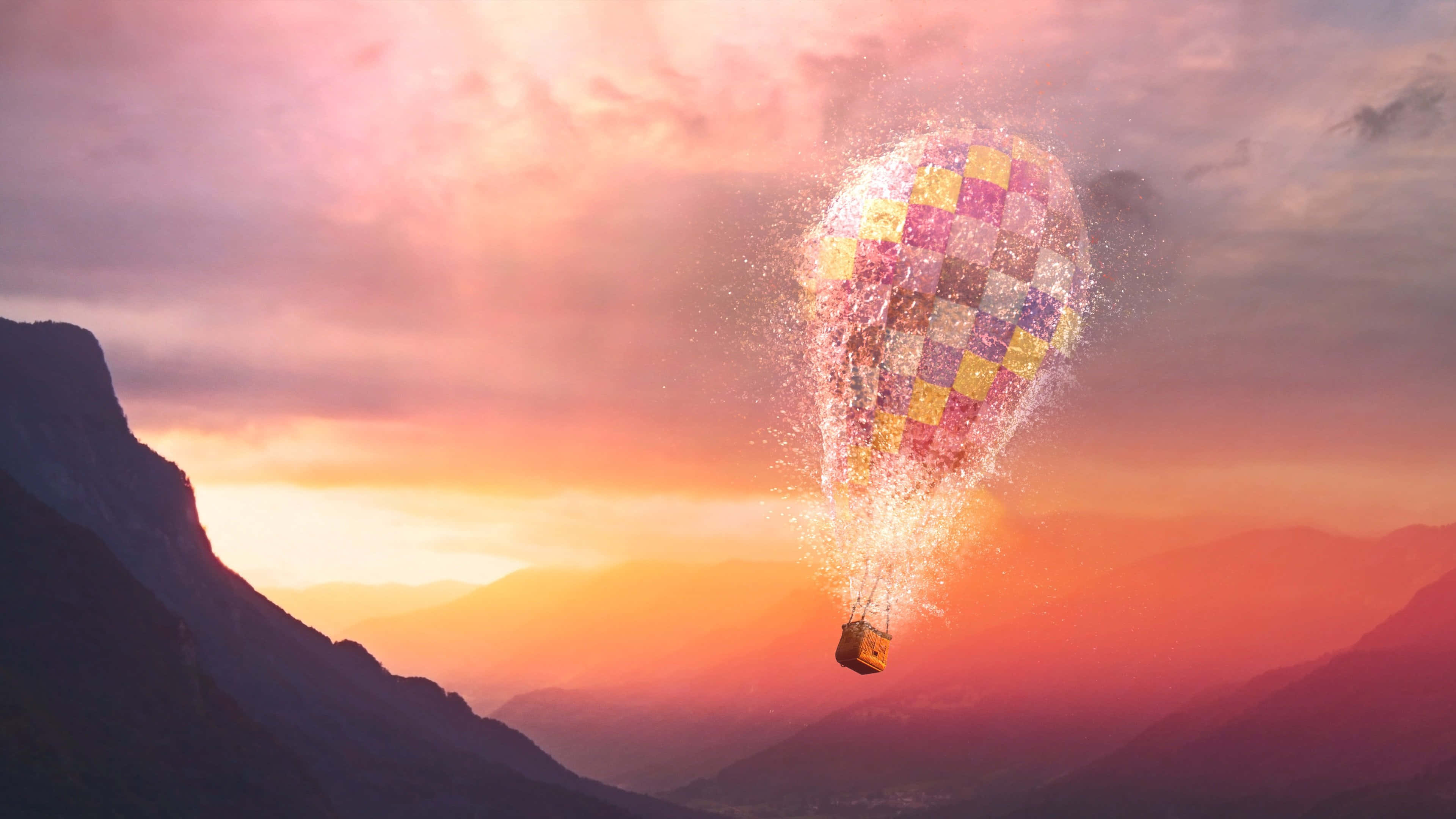 Hot Air Balloon 桌布 壁紙 — 一個格子熱氣球在日落時分於山區地形上空，化作閃爍粒子消散。