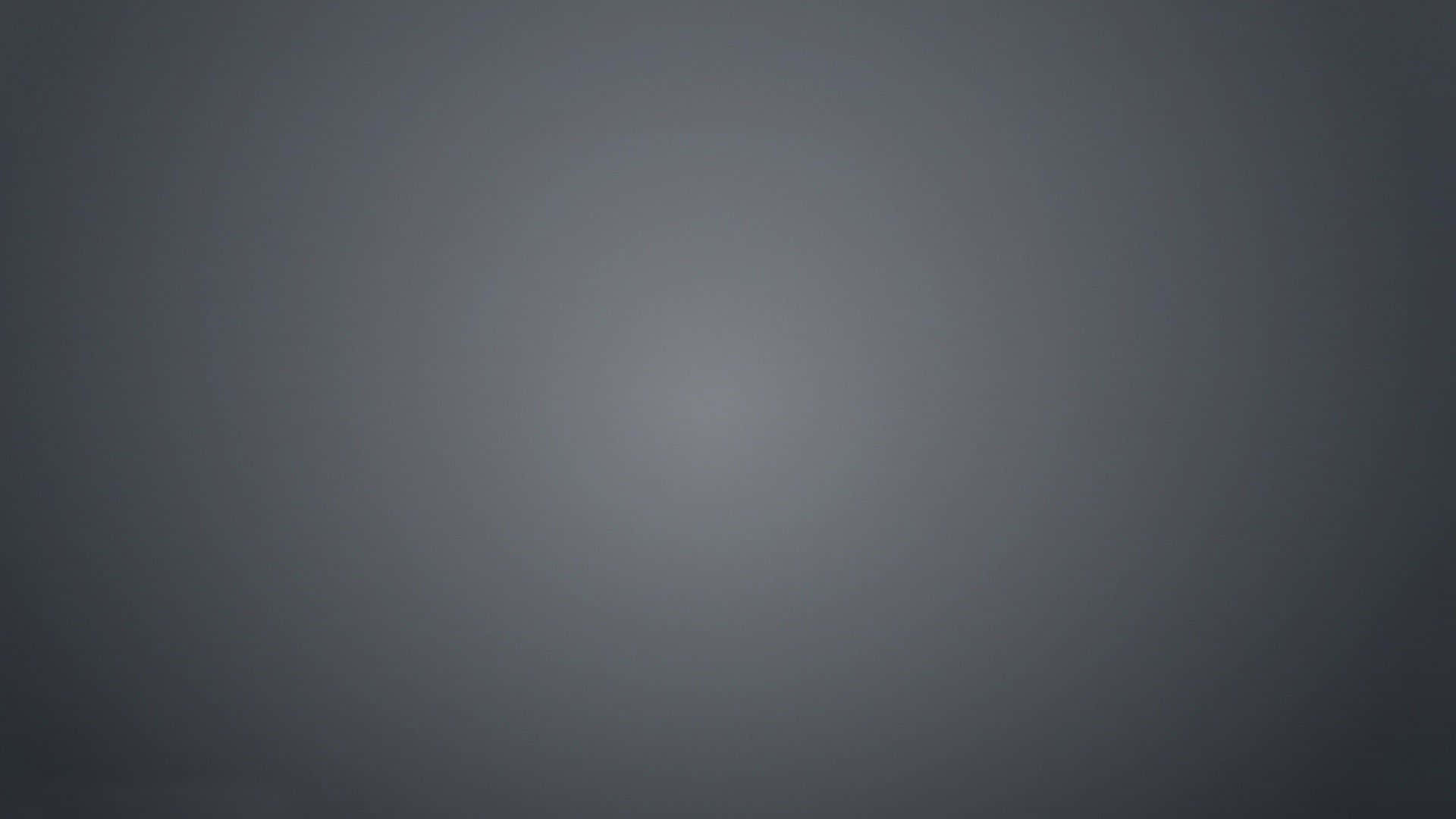 Grey Gradient 桌布 壁紙 — 一個極簡漸變背景，從深灰色過渡到淺灰色，帶有柔和放射狀照明。