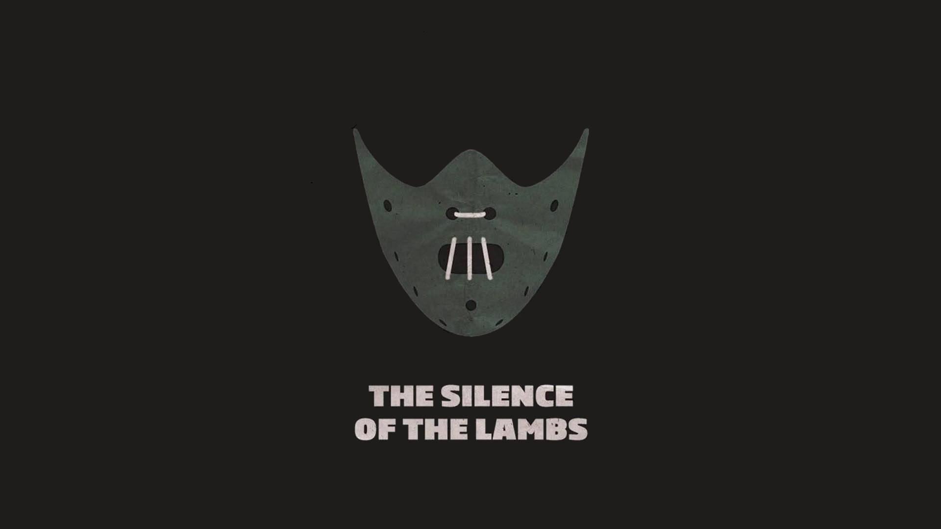 silence 桌布 壁紙 — 一個極簡灰色面具，有三個垂直牙齒和眼孔，居中在黑色背景上，帶有白色文字「THE SILENCE OF THE LAMBS」。