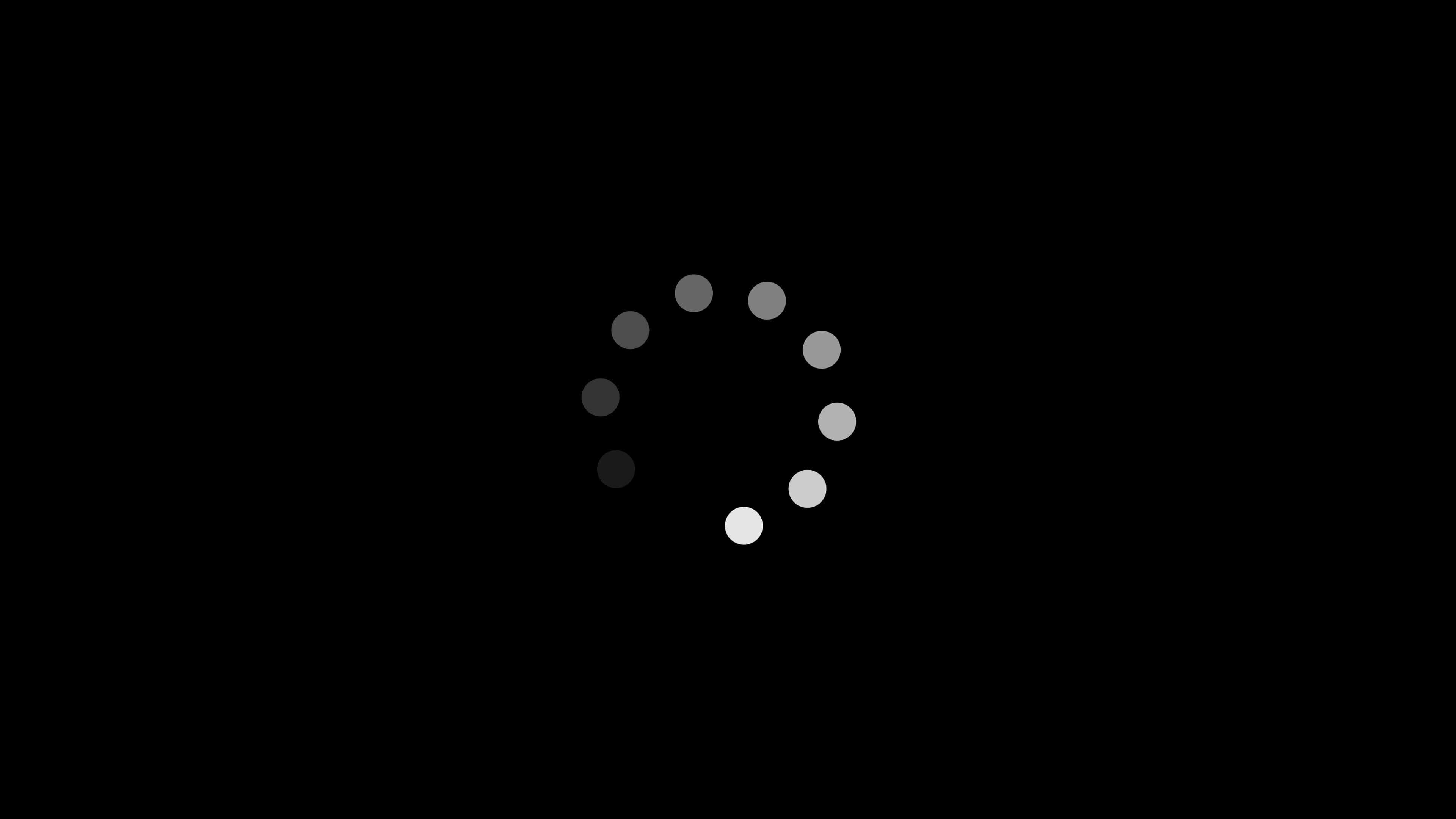 Loading 桌布 壁紙 — 一個極簡灰階載入旋轉器，帶有漸變點，在純黑色背景上旋轉。