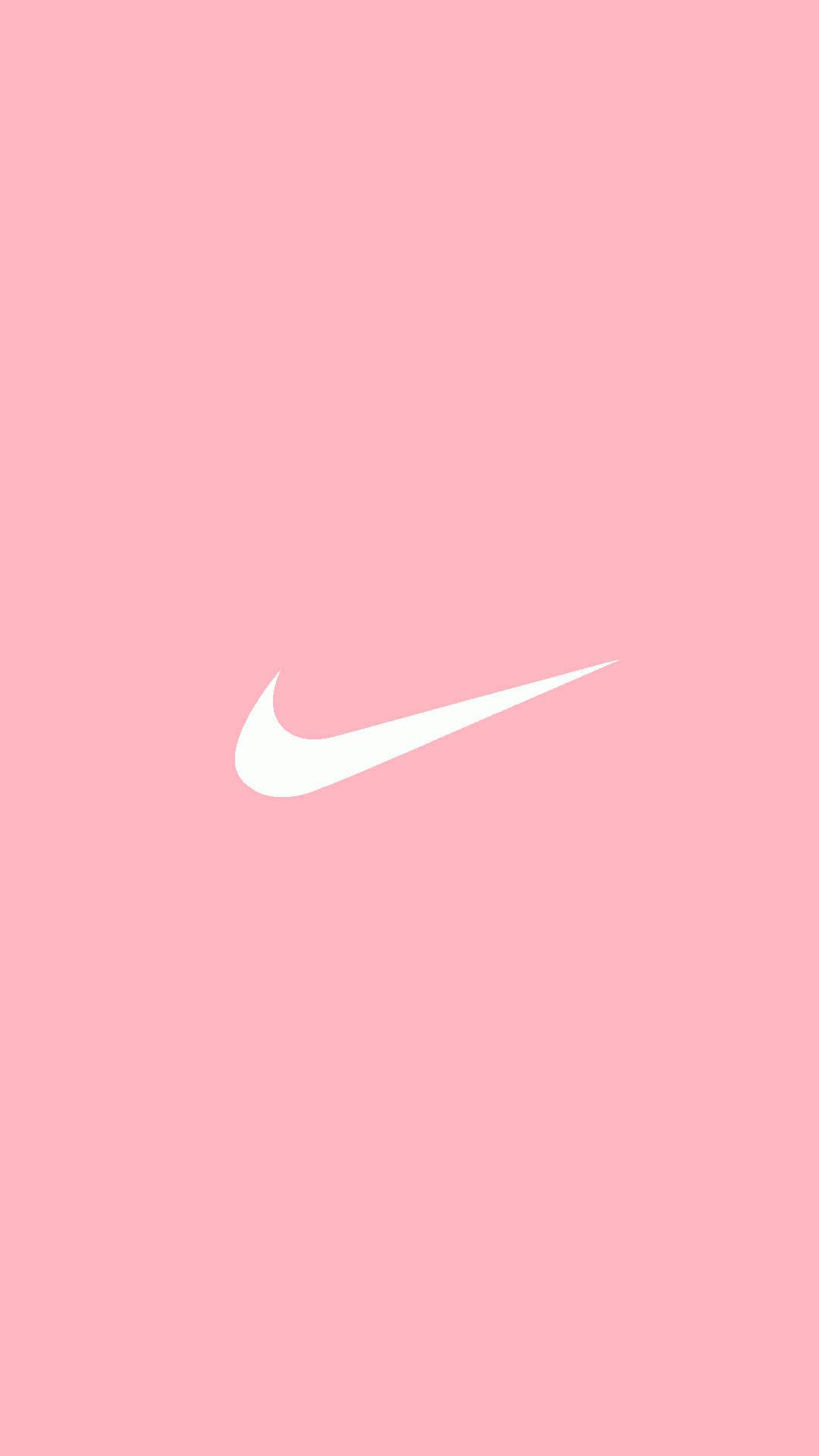 美學粉色GIF 桌布 壁紙 — 一個極簡白色Nike勾勾標誌，居中放置在純色柔和粉紅色背景上。
