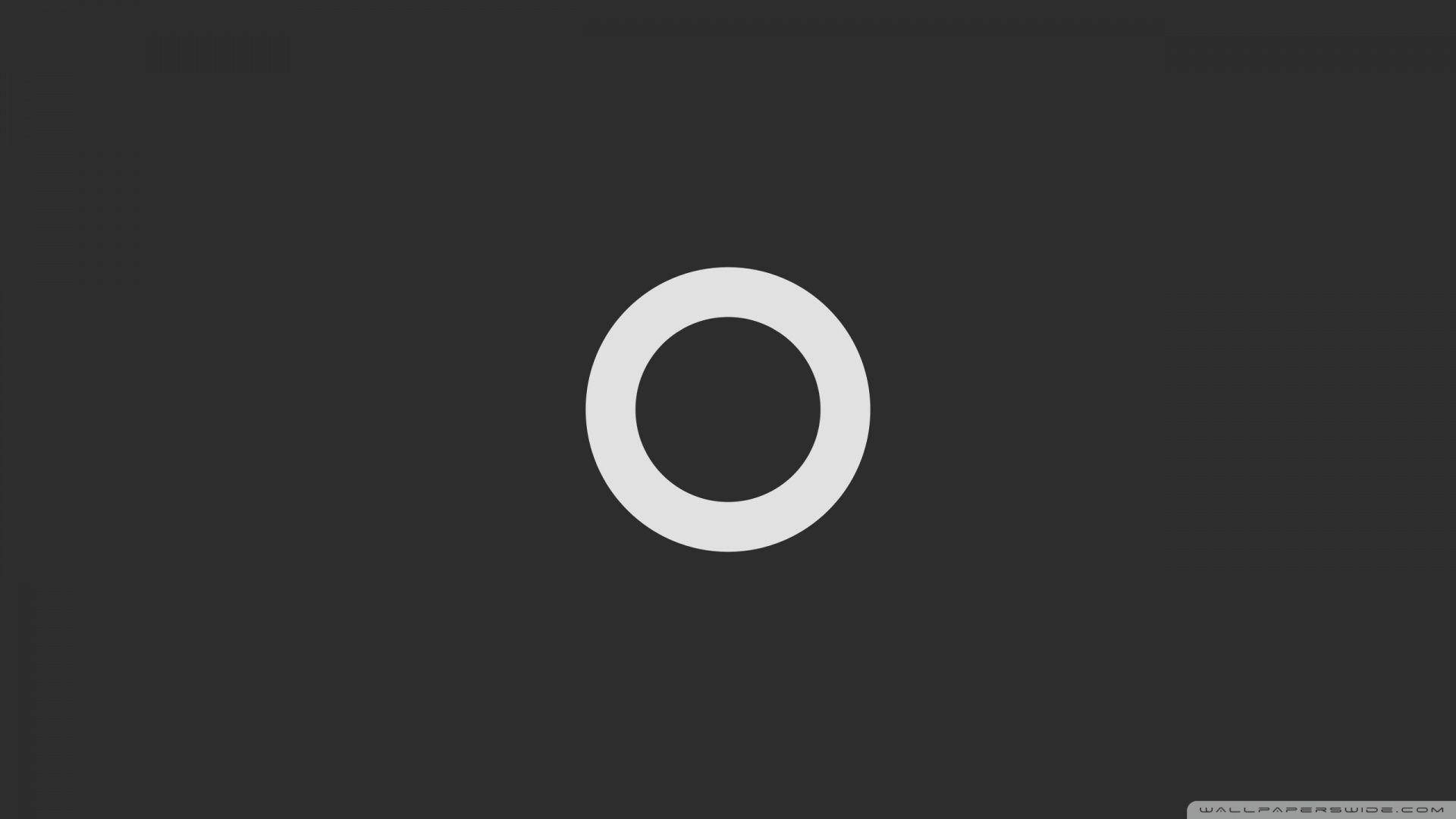 Outline 桌布 壁紙 — 一個極簡白色圓環，居中於帶有細微紋理的深灰色背景上。