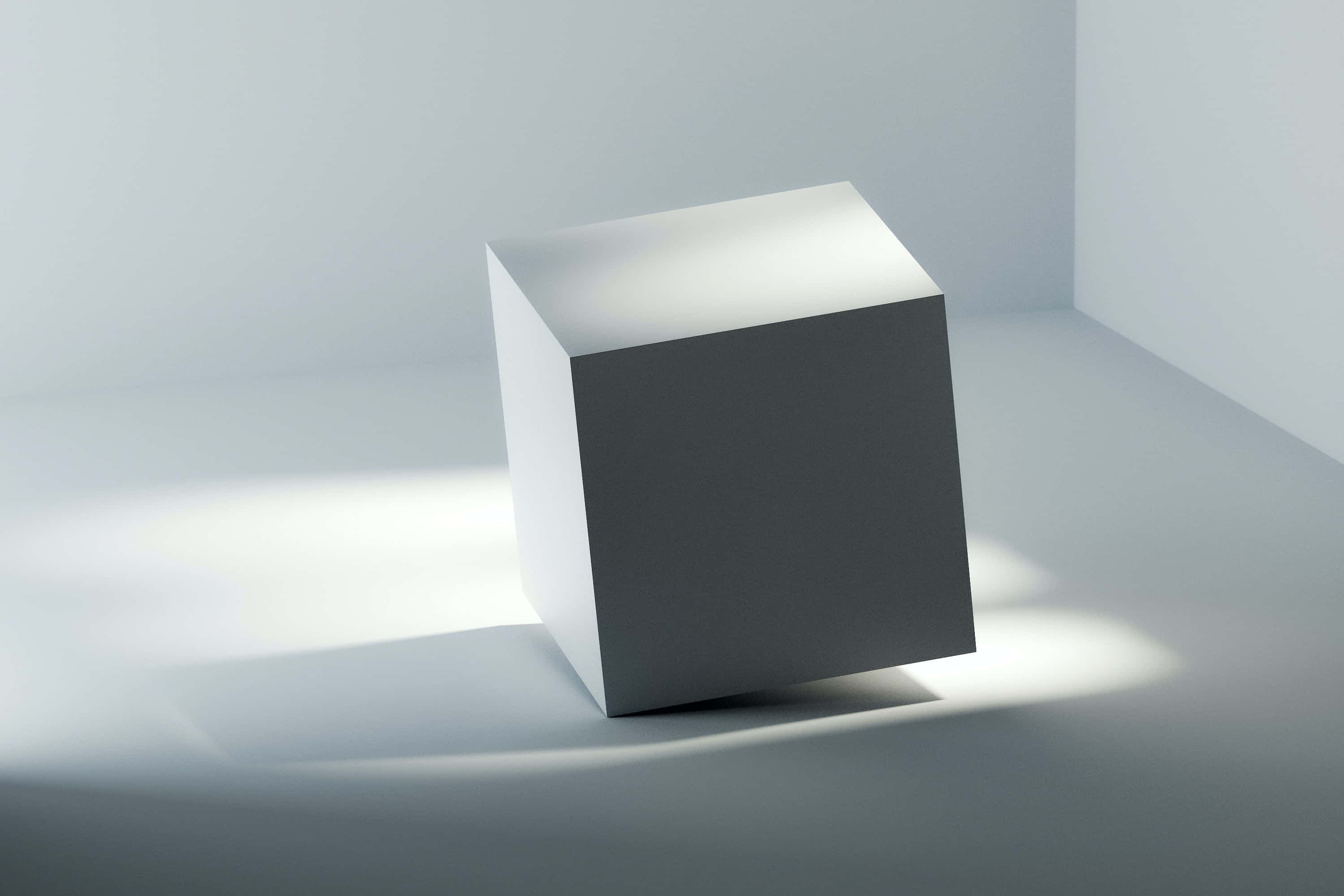3D 桌布 壁紙 — 一個極簡白色立方體放在角落，沐浴在柔和的方向光中，在乾淨的灰色地板上投下銳利的陰影。