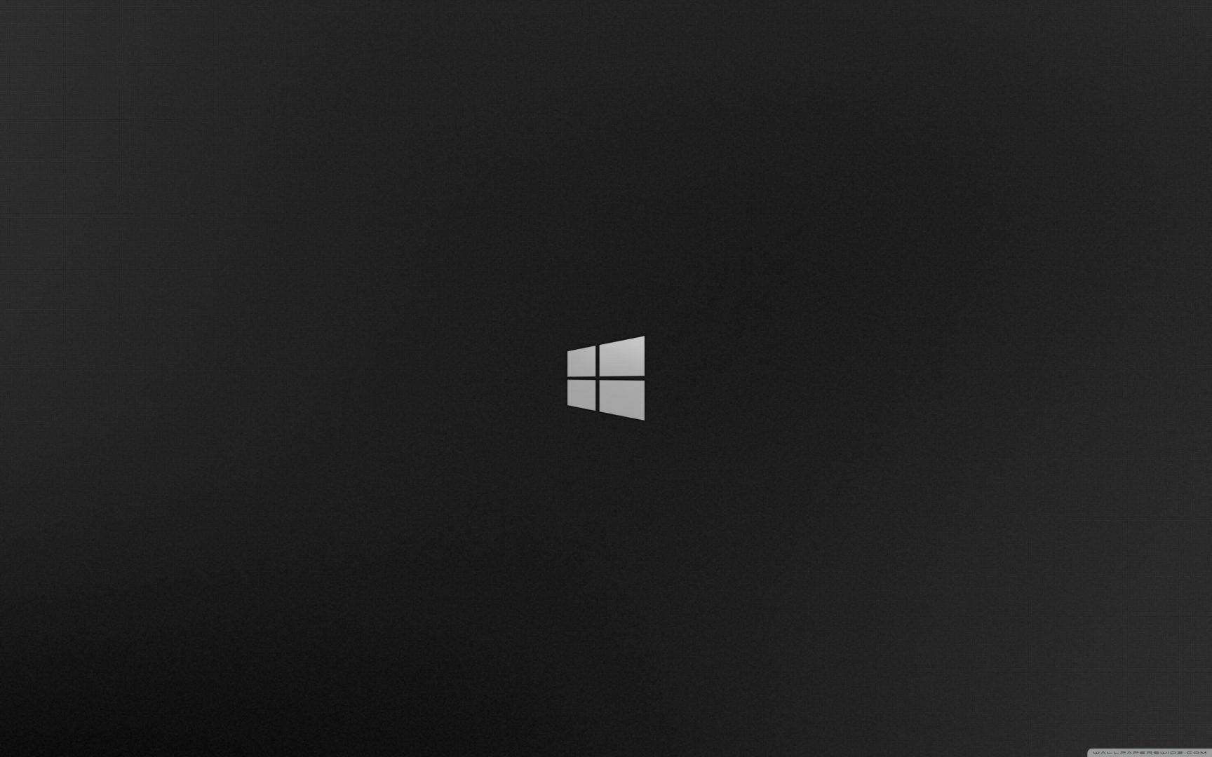 Windows 95 動態圖 桌布 壁紙 — 一個極簡的Windows標誌，居中放置在帶有細微漸變的紋理深灰色背景上。