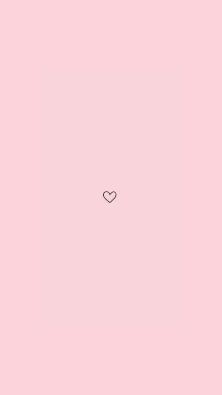 Vsco 桌布 壁紙 — 一個極簡的心形輪廓，居中在柔和的粉紅色背景上。