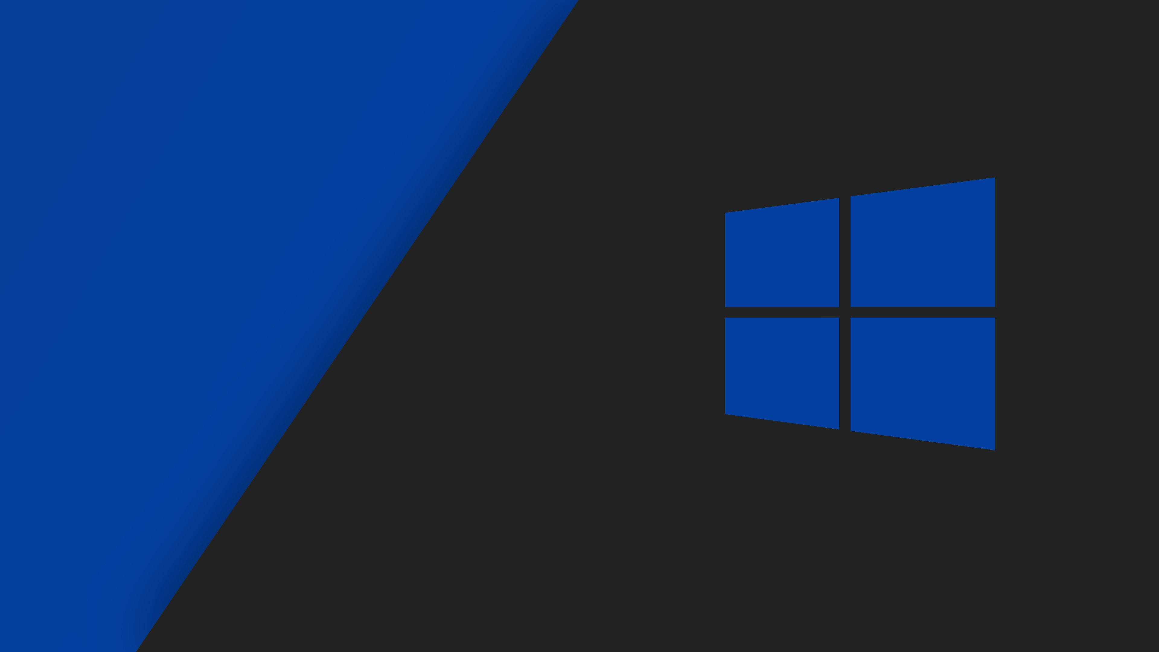 Windows 10 高畫質 桌布 壁紙 — 一個極簡的數位桌布，在深灰色背景上帶有藍色Windows標誌和對角藍色漸變。
