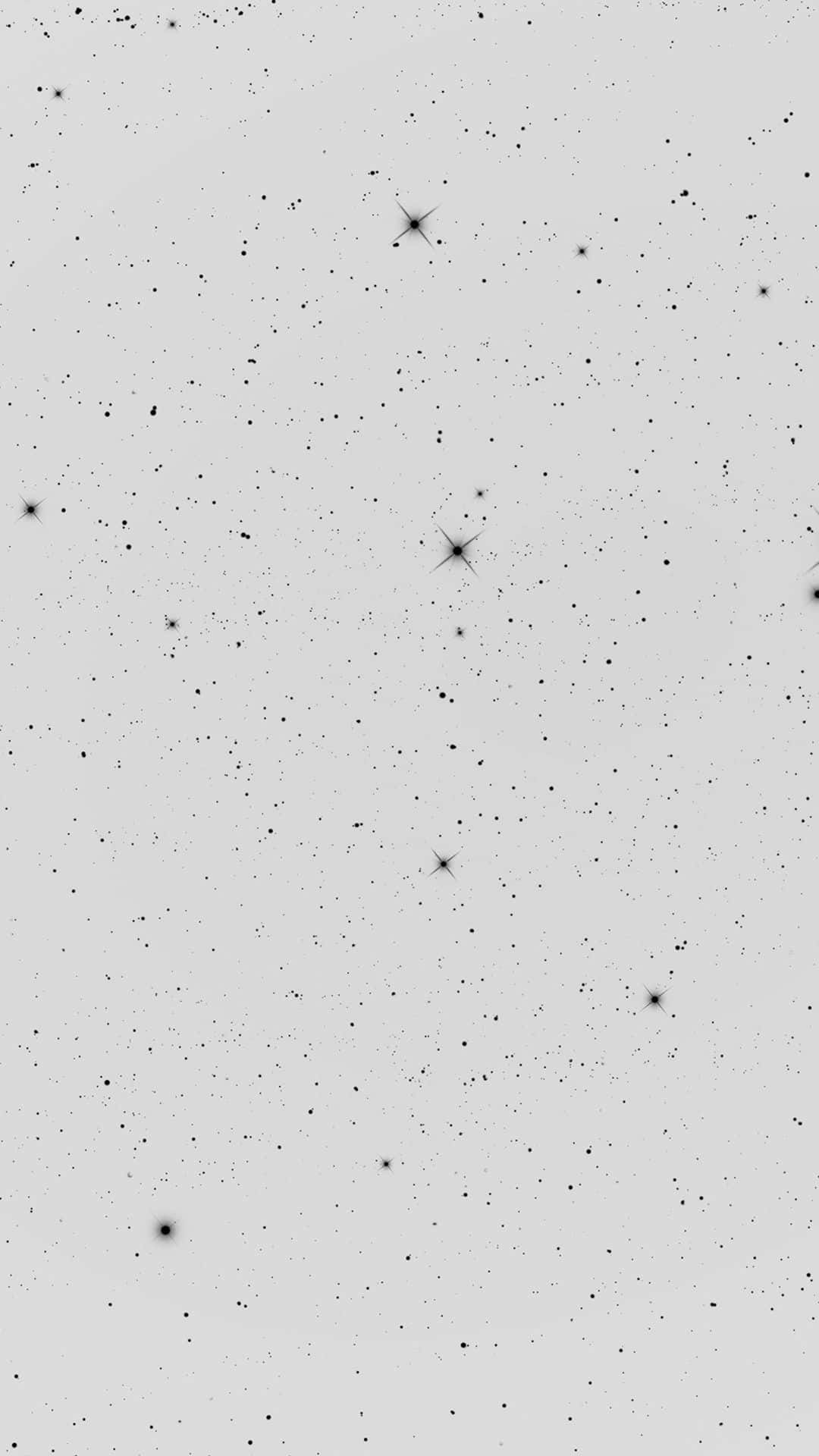 桌布 壁紙 — 一個極簡的星空，散落著發光的星星，背景是柔和的灰色。